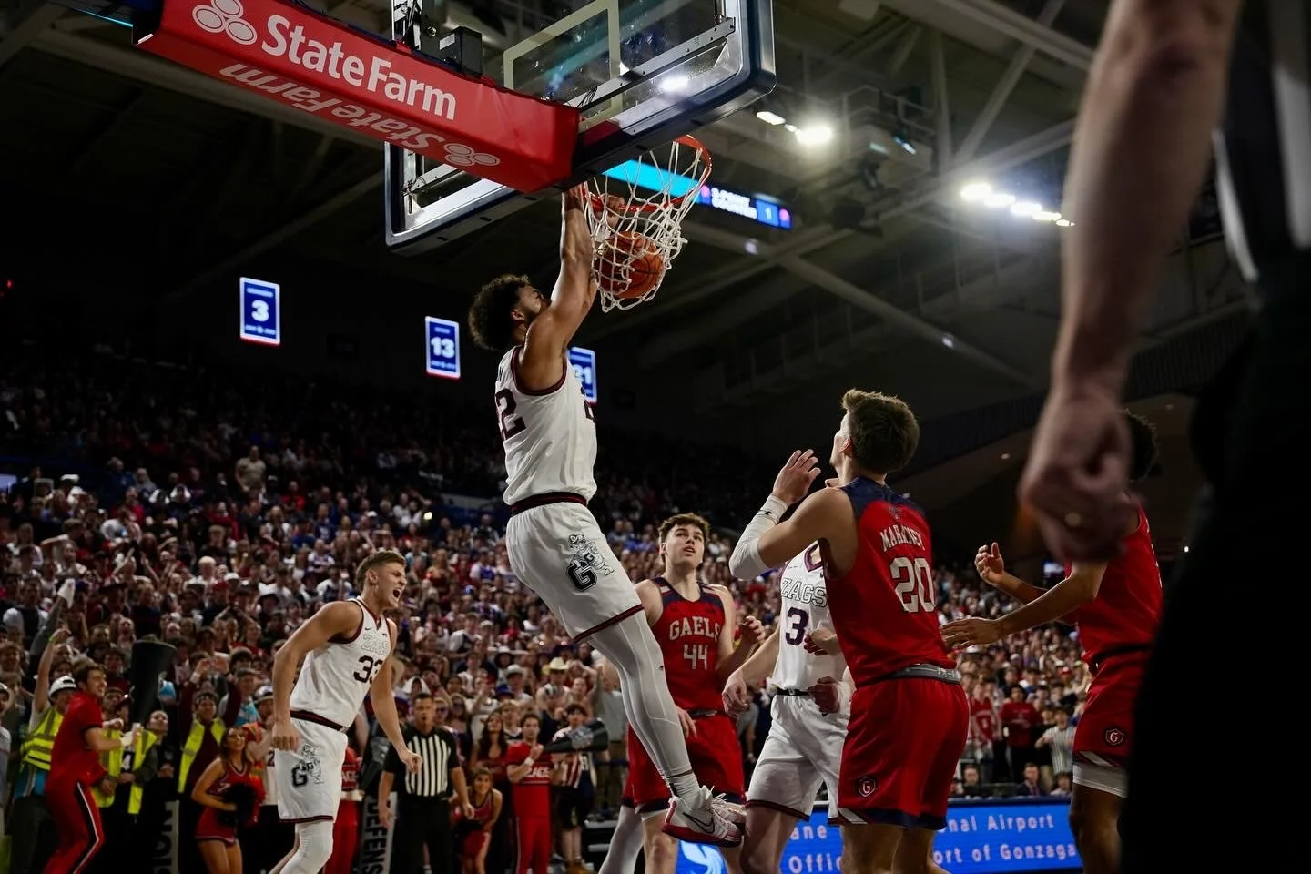 Basketball game action with player dunking