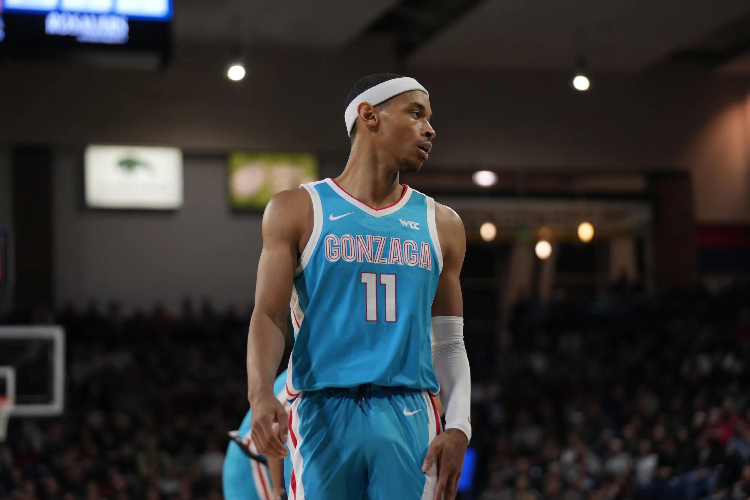 Basketball player in a Gonzaga uniform with number 11 on the court.