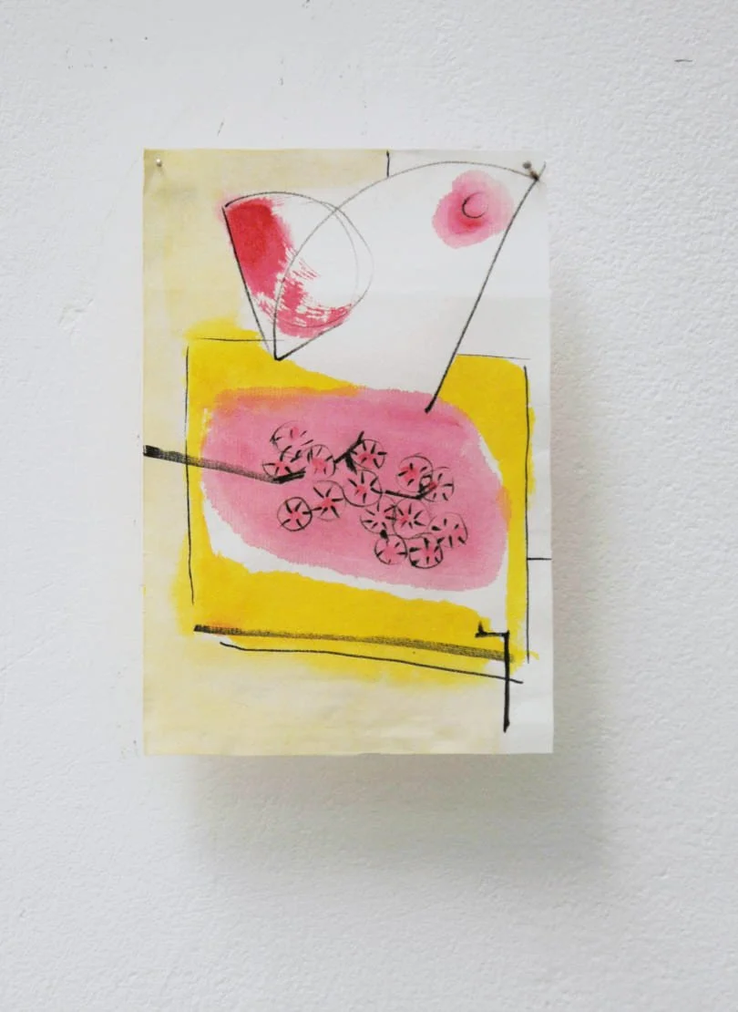 Abstract watercolor painting with geometric and organic shapes, including circles, lines, and patches of pink and yellow, pinned to a white wall.