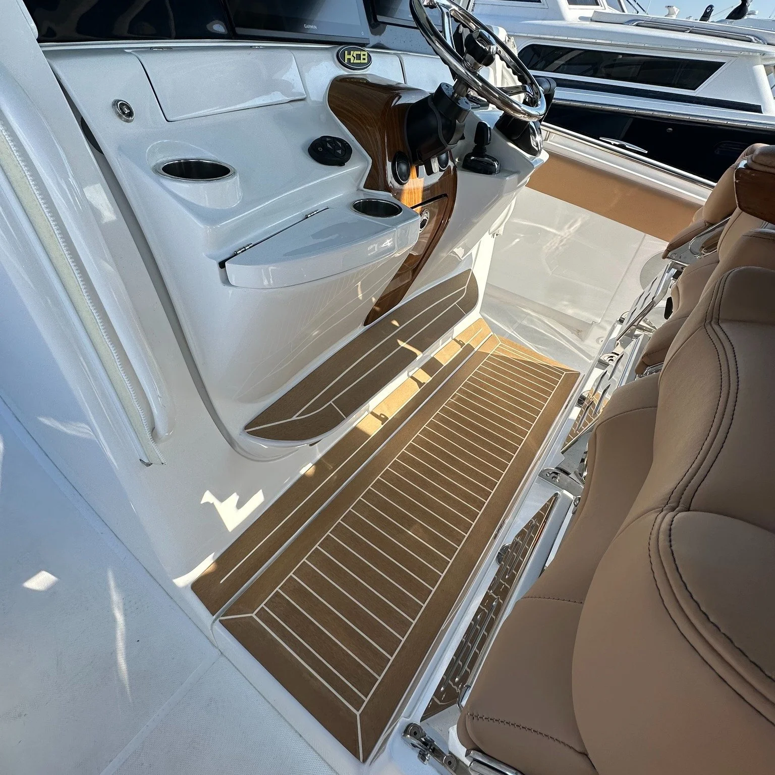 Our Permateek installation on this HCB beautifully complements its woodwork and upholstery.  This is Permateek's Elite line, Traditional Color with White caulking.  #hcbboats #permateek #flyingbridgemarina