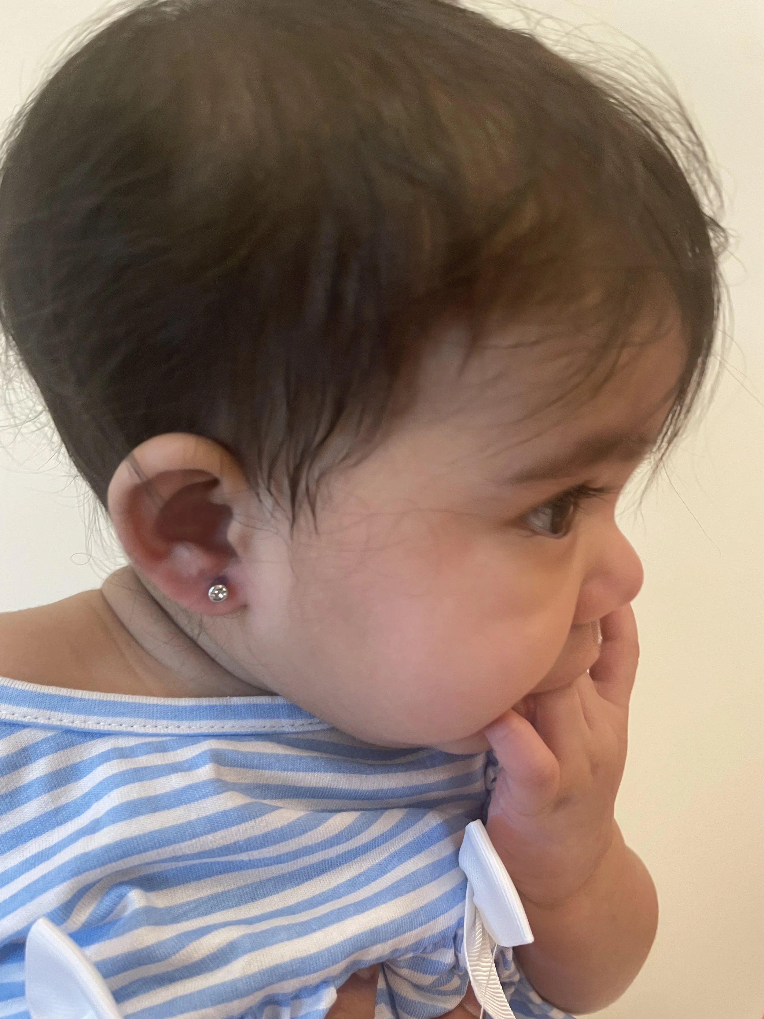 Baby ear piercing performed by board-certified pediatrician at Rise and Shine Pediatrics in Boca Raton FL