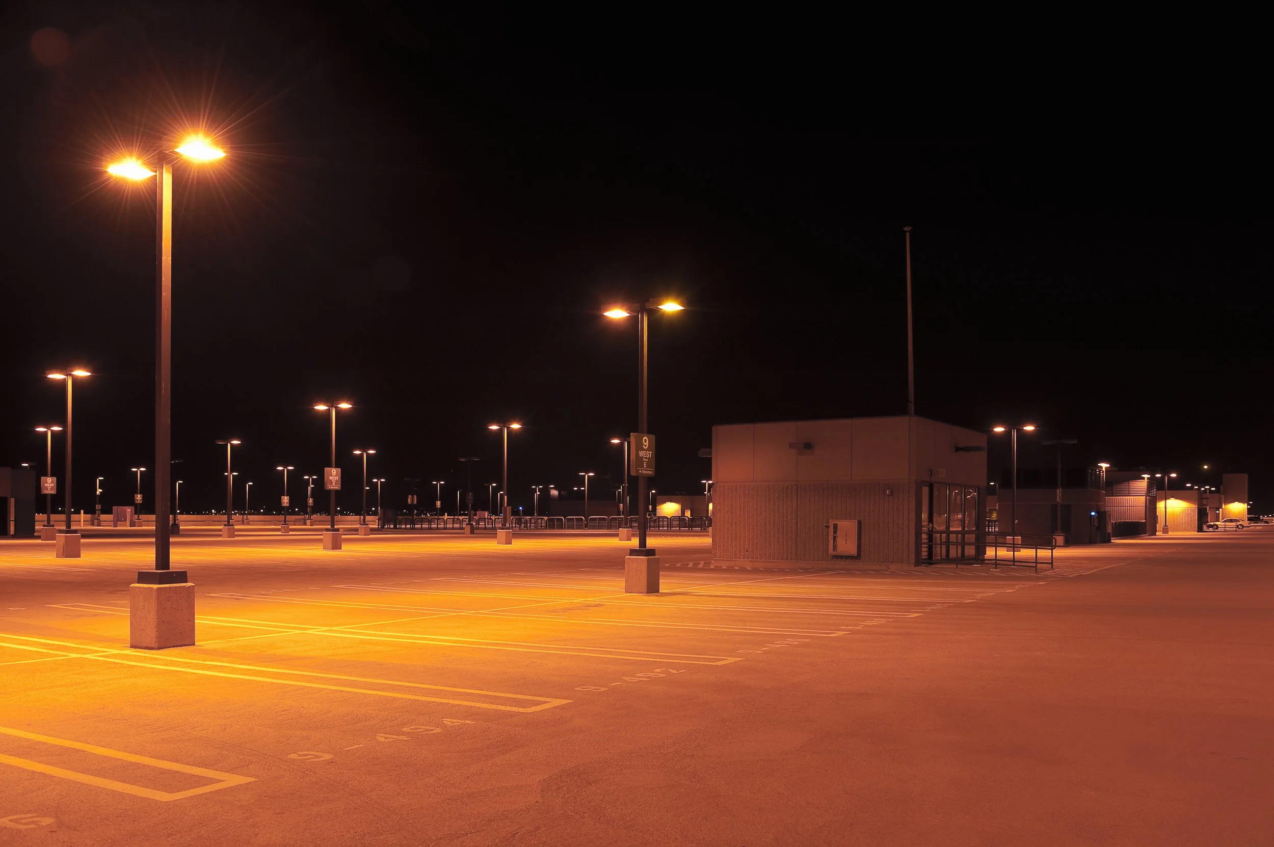 Parking Lot Lighting in a dark lot installed by Bakers' Signs