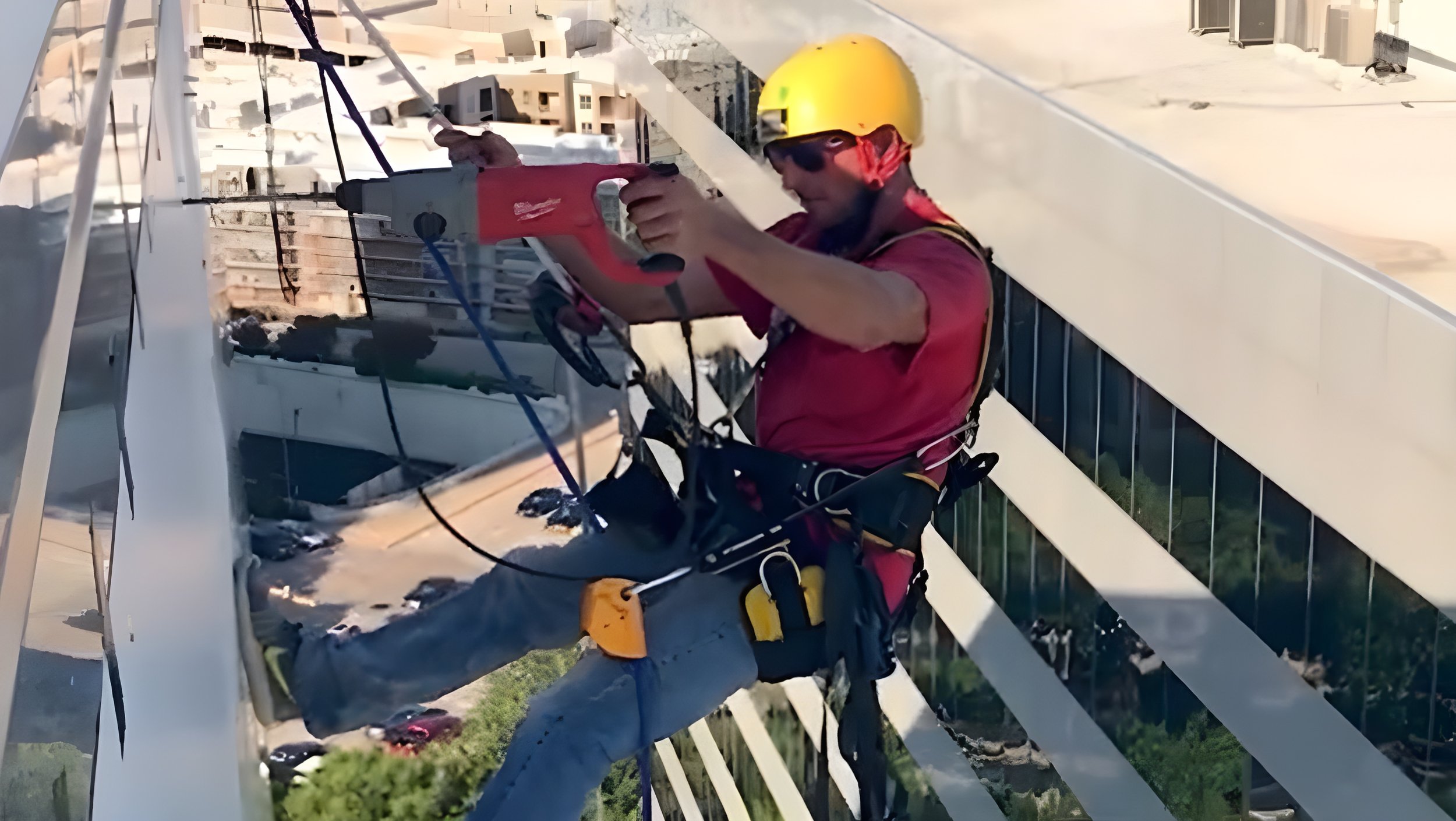 Bakers' Signs Employee Installing a Sign on a Building
