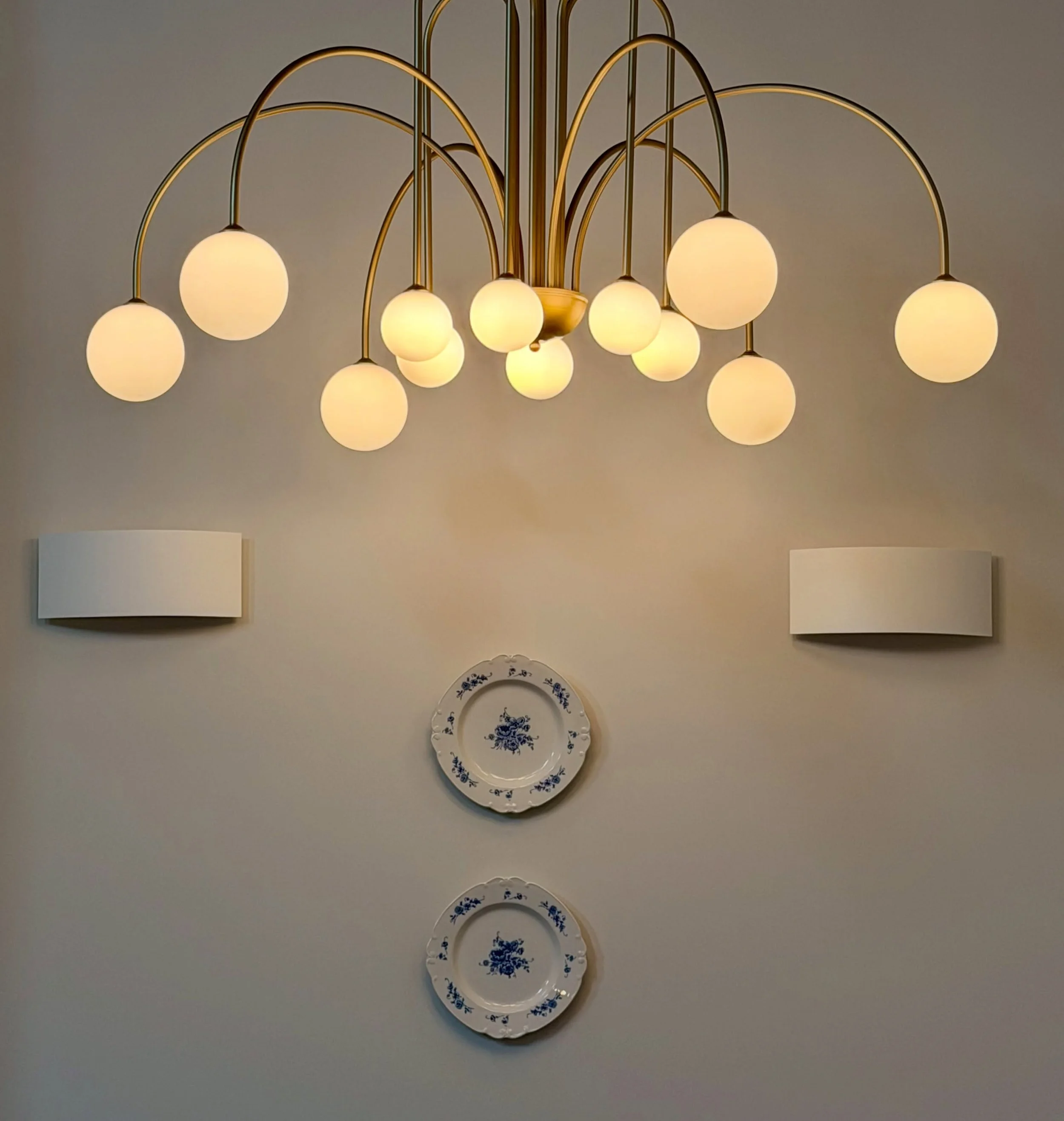 Different Lighting, Same Design Language

Who says lighting fixtures in an open concept space have to match?

For this project, we chose different shapes and styles for the kitchen island, dining area, and coffee station, while keeping a cohesive loo