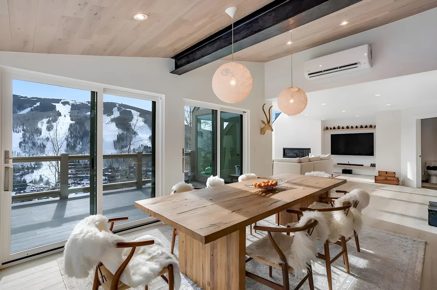 Dining room with a live-edge table and ski-slope views, Mountain Retreat in Vail