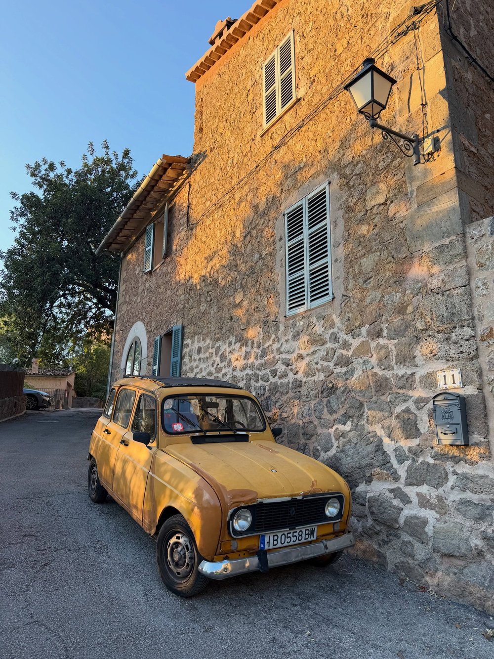 Stone house with a yellow vintage car