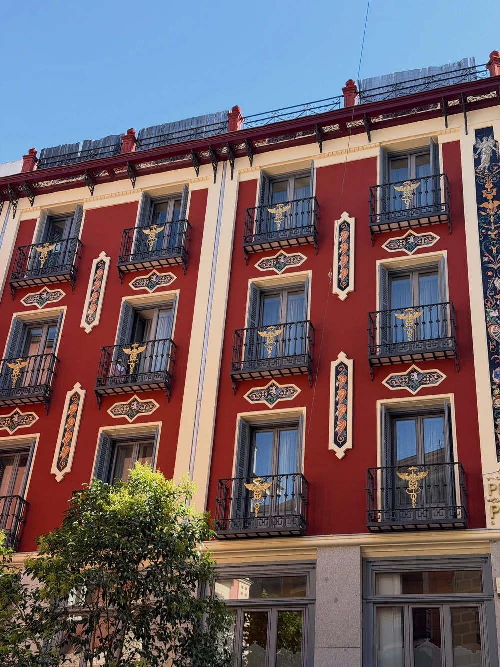 Red Madrid facade with balconies