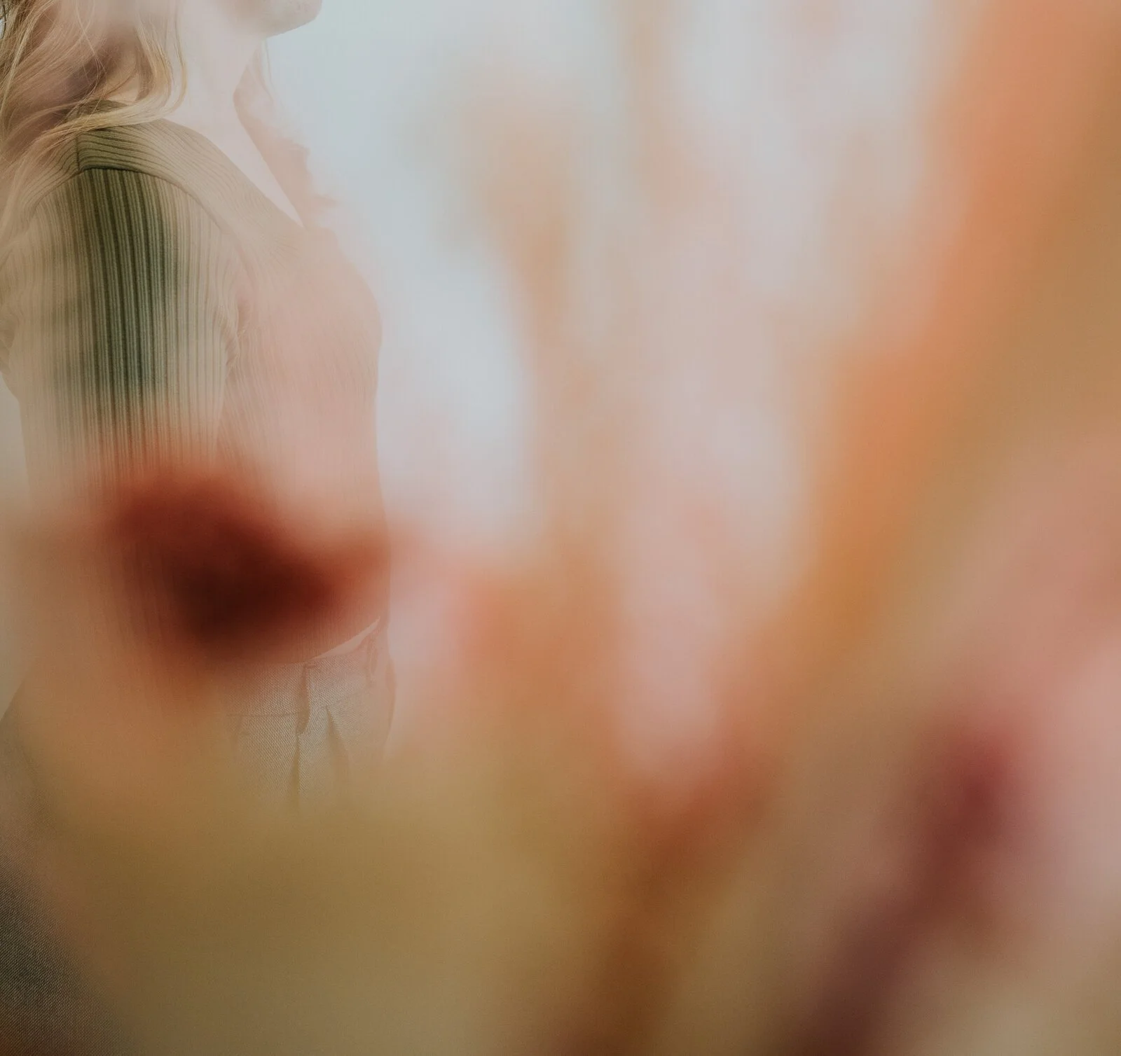 A close-up of a person's face with blurred features, making it difficult to discern specific details.