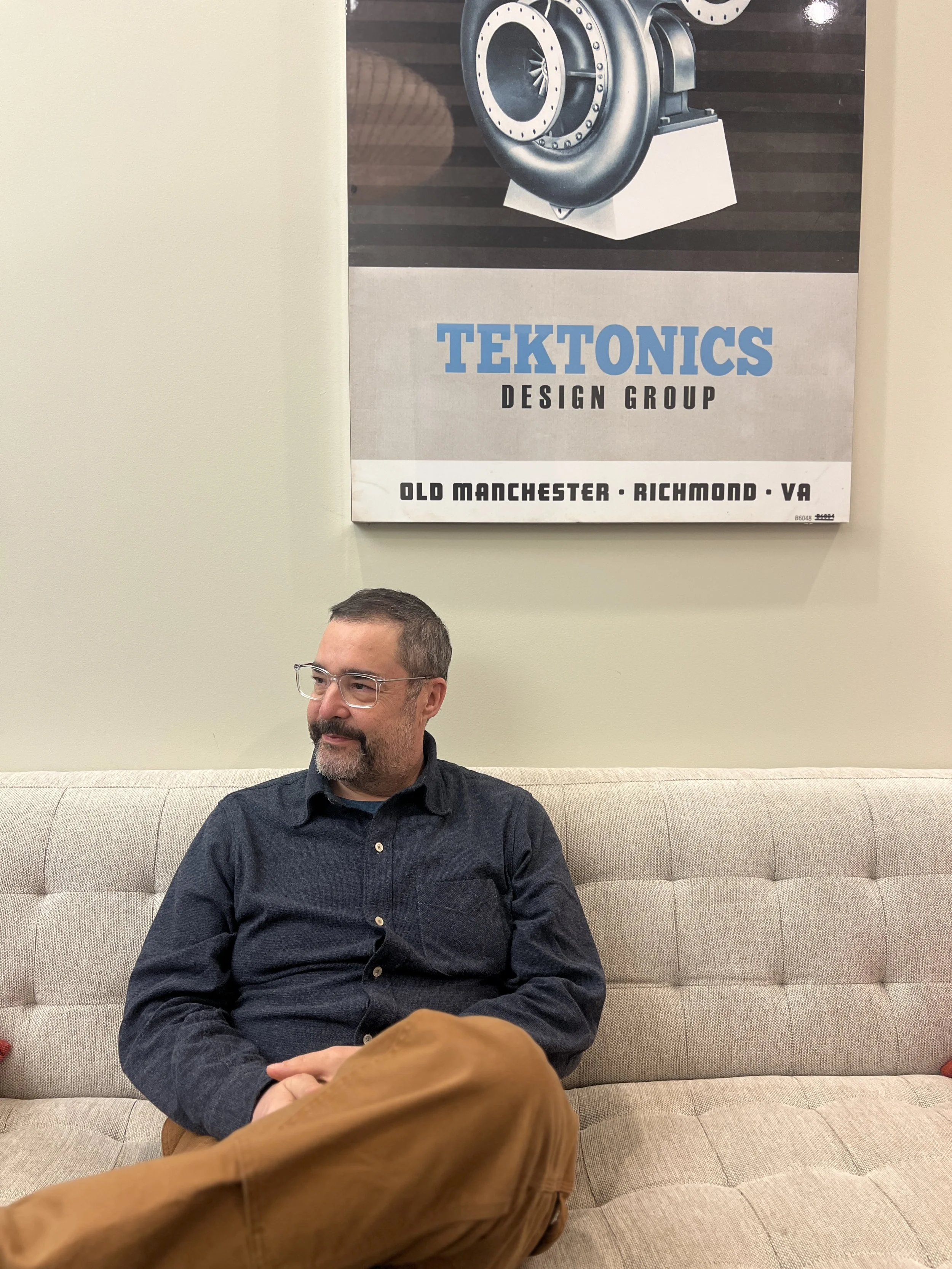 Christopher Hildebrand founder of Fern & Roby and Tektonics Design Group, sitting in the Tektonics offices