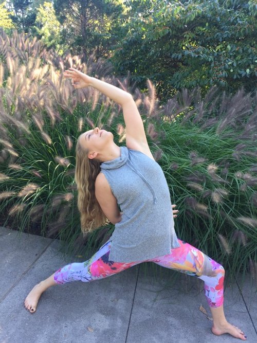 Cassi Starc trained yoga and mindful self compassion teacher in reverse warrior yoga pose.