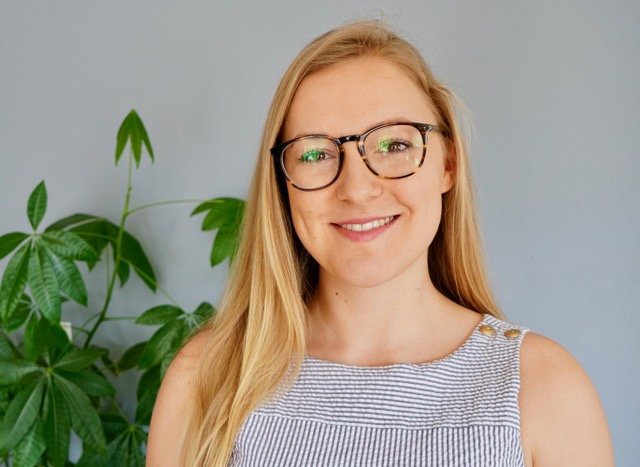Cassi Starc, trained Mindful Self Compassion teacher, smiling with plants in background.