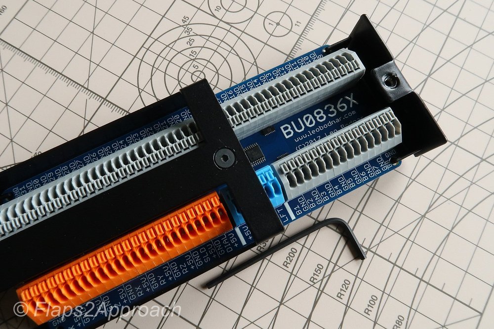 BU0836X and metal enclosure with slide partly open.  Allen key for scale