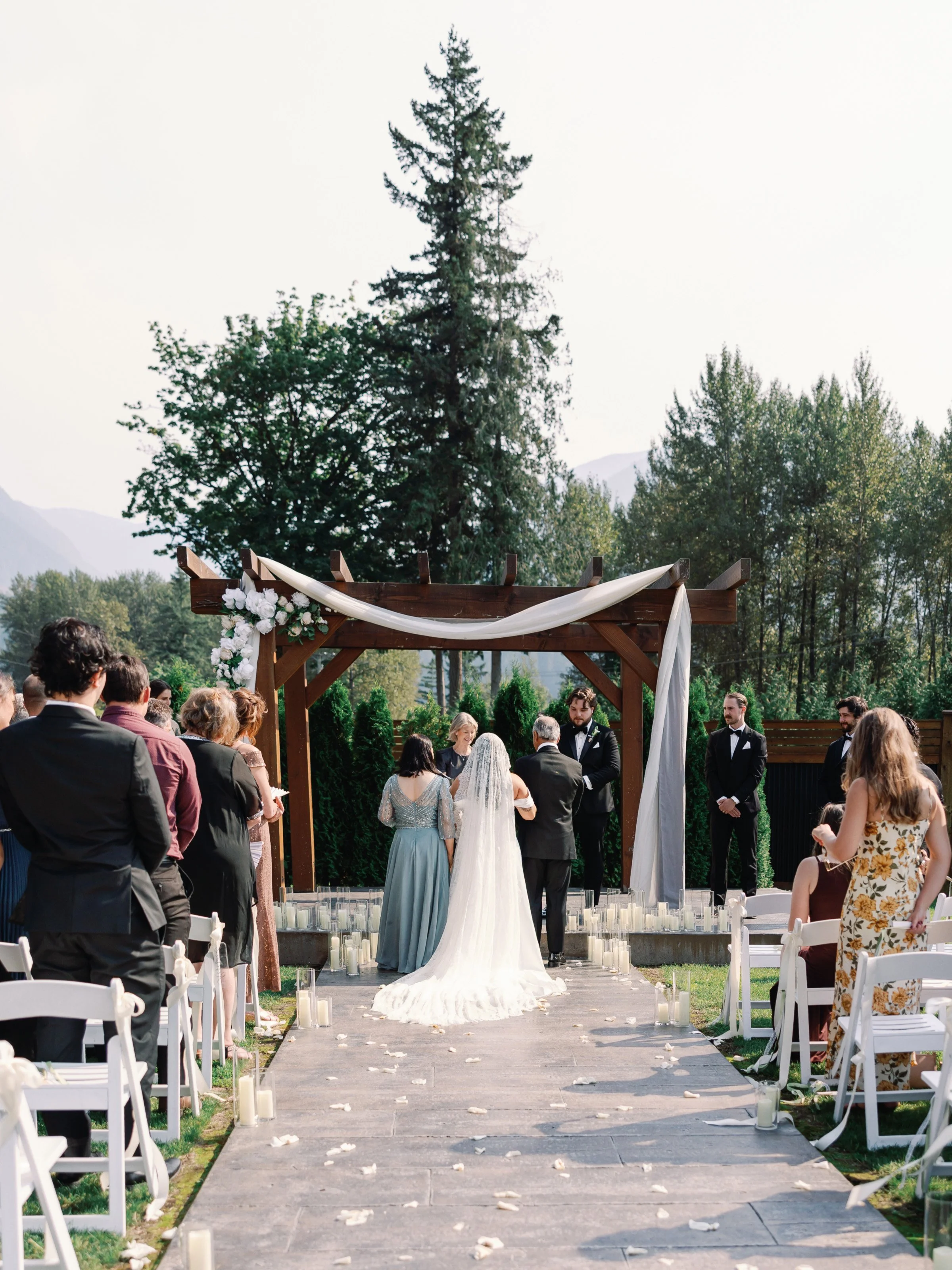 Romantic outdoor wedding ceremony at Bridle Woods Event Centre with the couple exchanging vows surrounded by florals and countryside views.