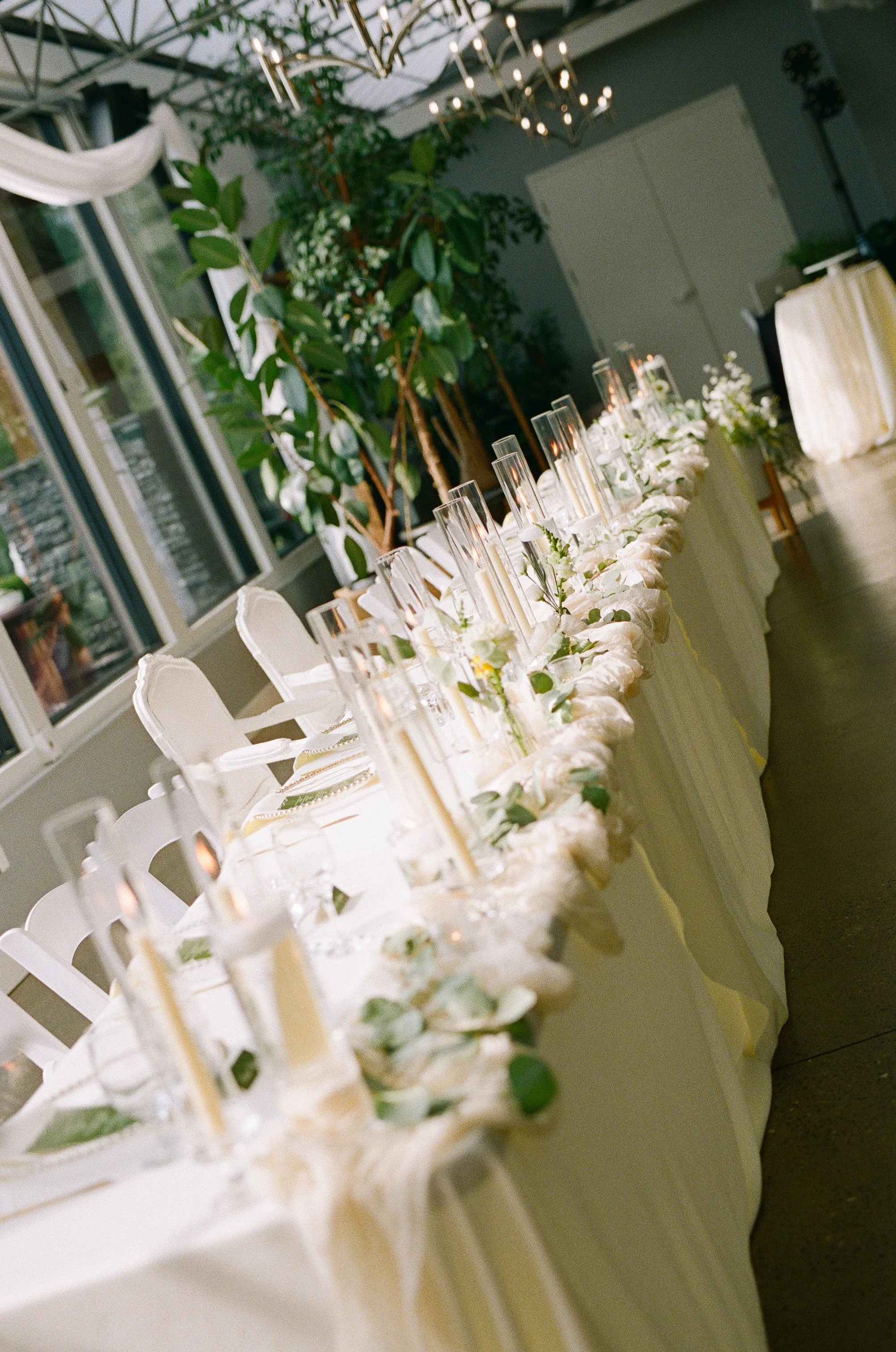 Elegant wedding reception details including textured linens, refined place settings, and glowing candlelight inside Bridle Woods Event Centre, captured in a timeless film-inspired style.