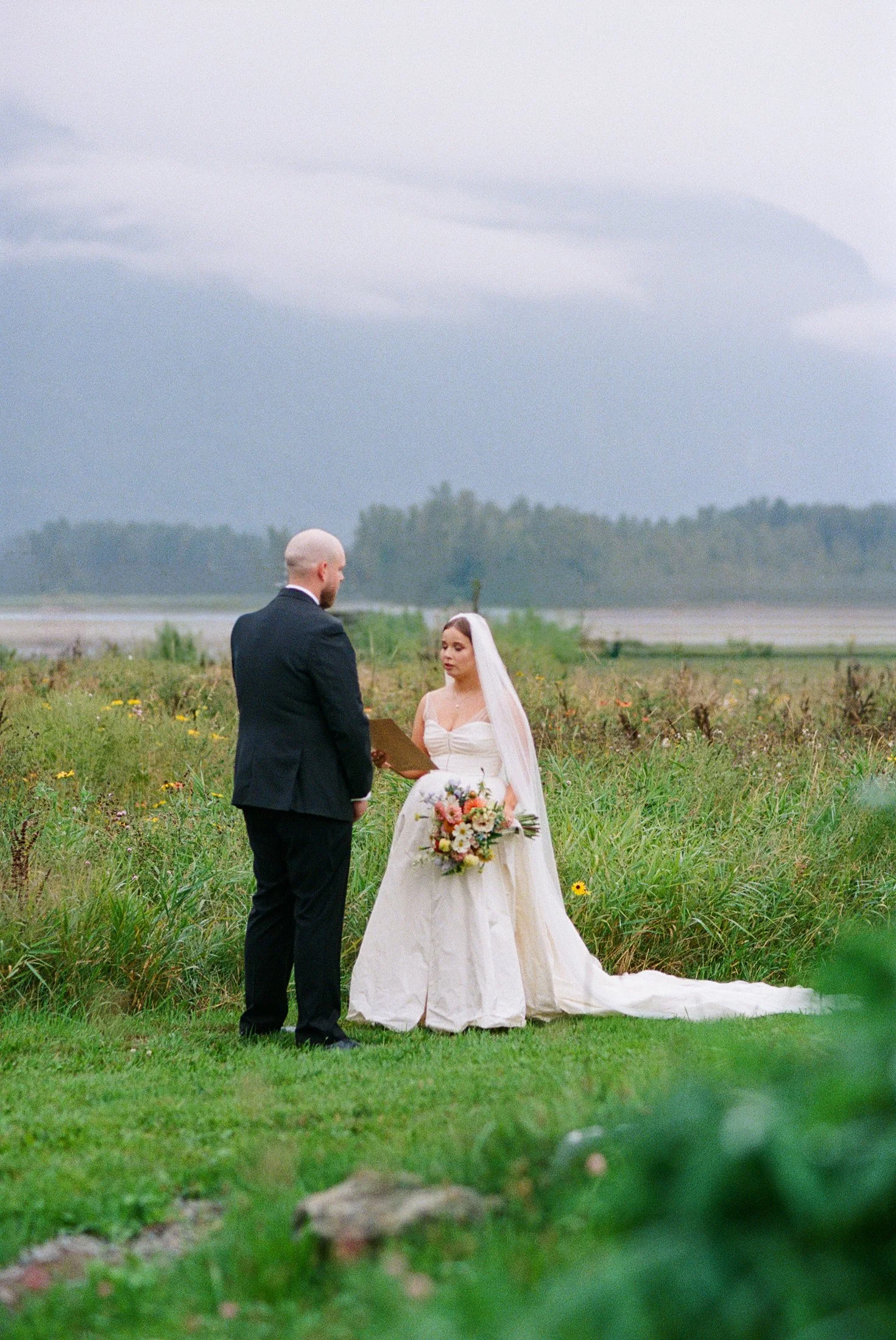 Private vow exchange at Fraser River Lodge in the mountains — intimate couple moment photographed in a cinematic editorial style using hybrid film and digital wedding photography.