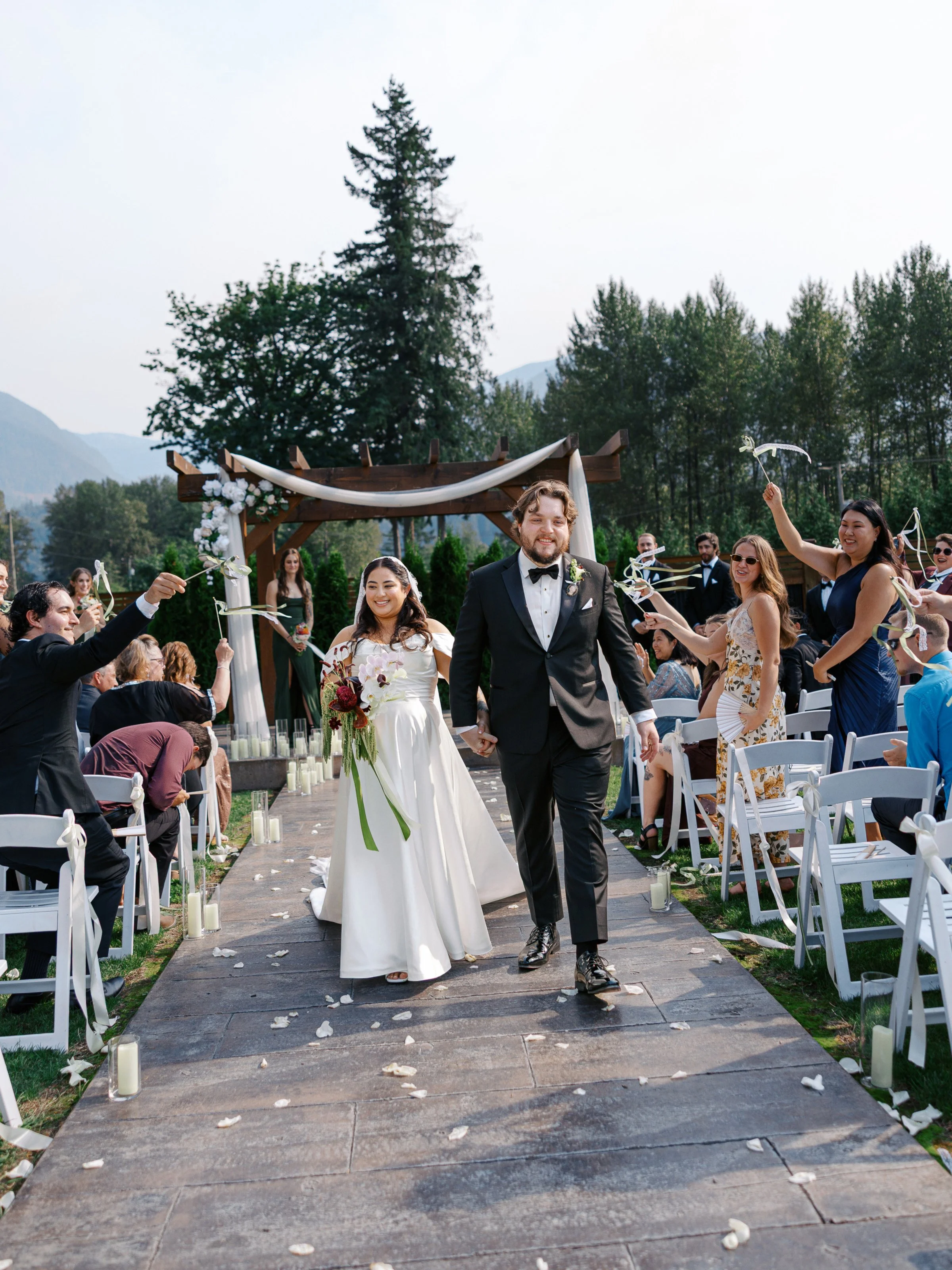 Candid ceremony photography documenting heartfelt expressions, guests witnessing the vows, and a timeless outdoor setting.