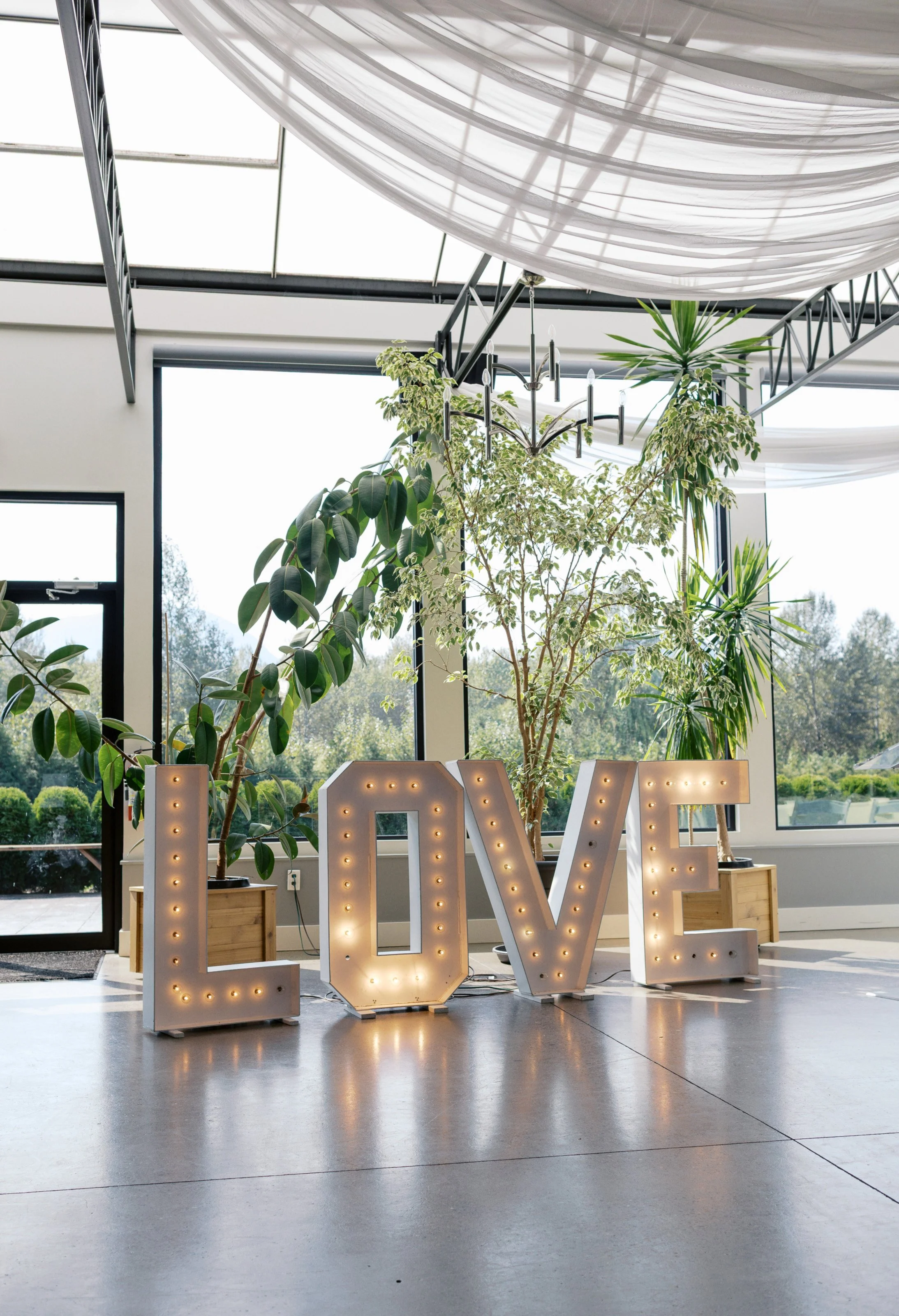 Refined indoor wedding reception scene featuring curated table decor, florals, and elegant details at a Fraser Valley countryside venue.