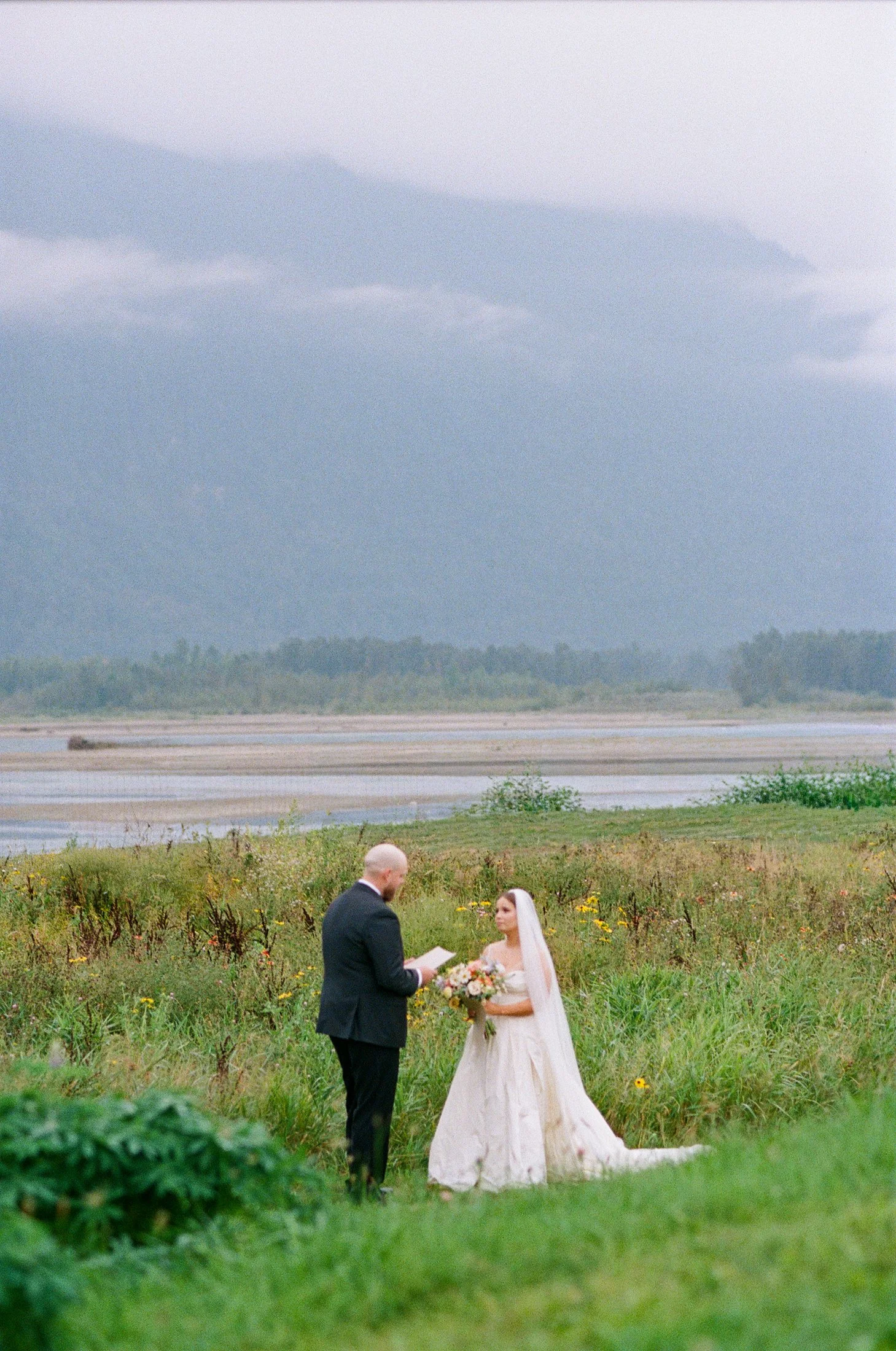 Fraser River Lodge private vows with mountain views, emotional candid moments between bride and groom documented using a mix of 35mm film and digital photography.