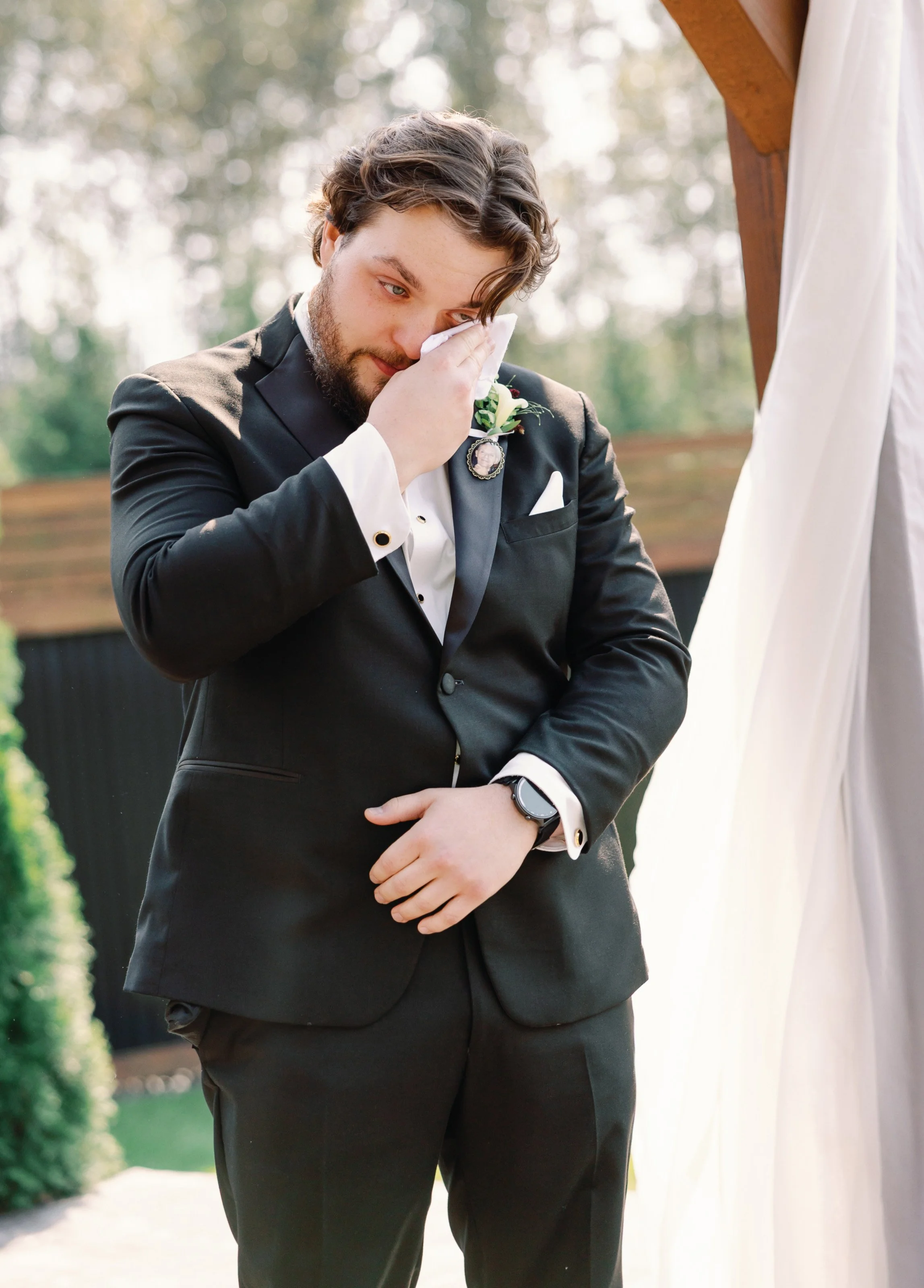 Bride and groom saying their vows beneath an elegant floral ceremony setup at a countryside Fraser Valley wedding venue.