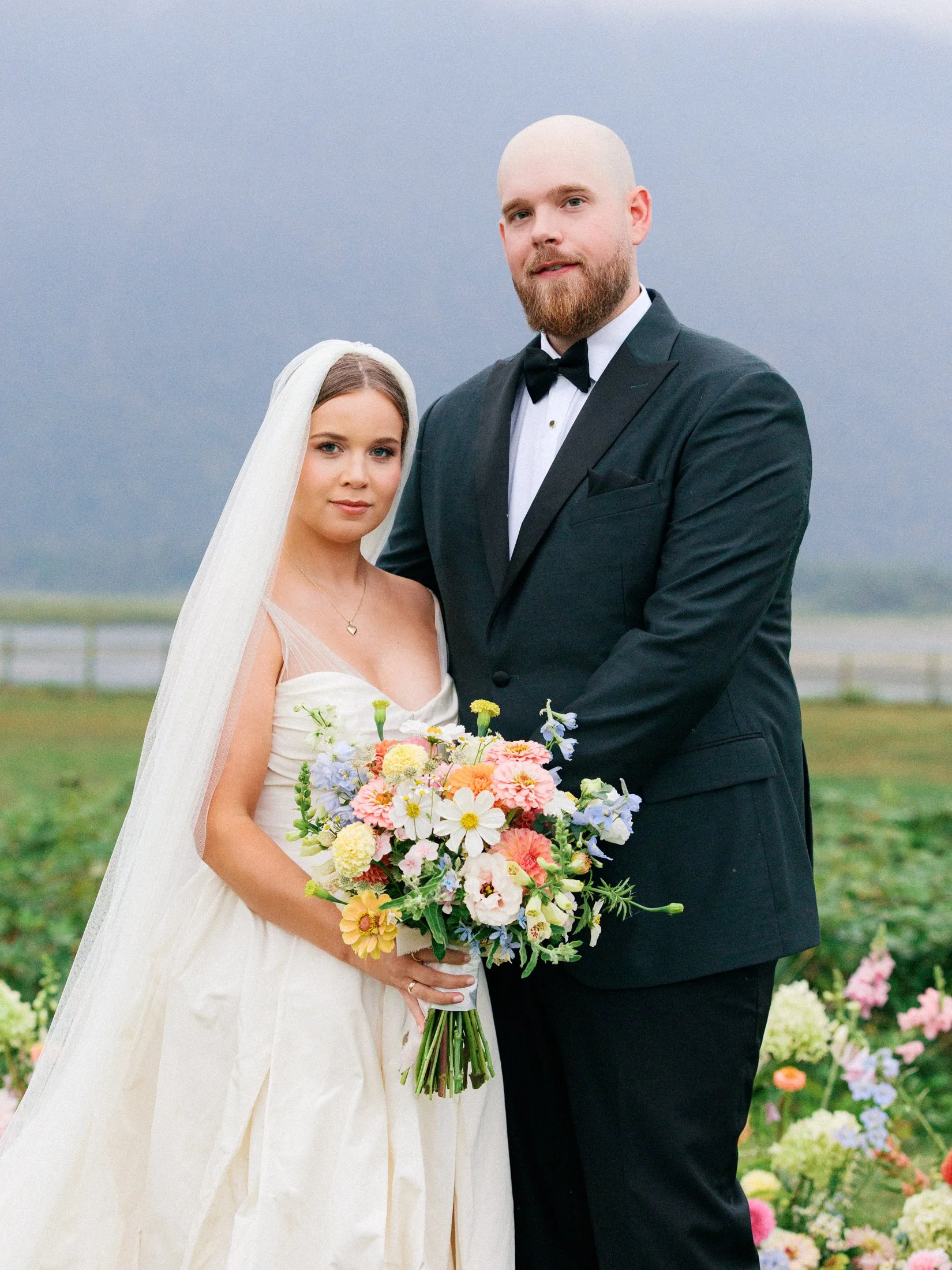 Fraser Valley wedding portraits at Fraser River Lodge — editorial outdoor couple session beside ceremony decor, photographed in a timeless digital and film approach.