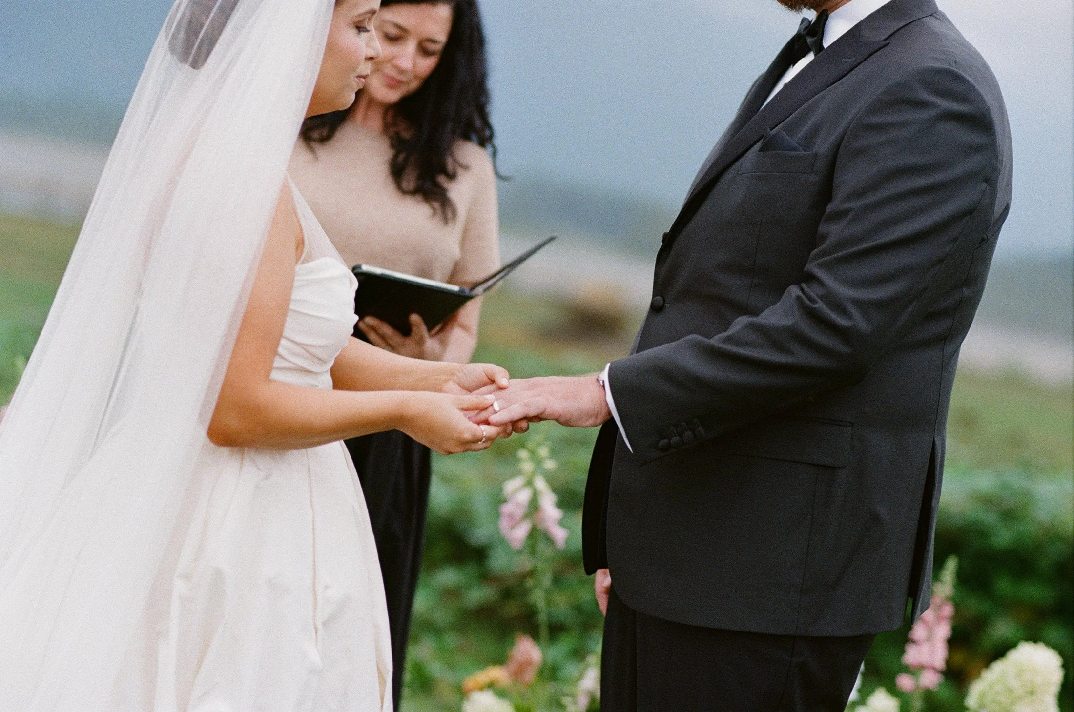 Fraser River Lodge ceremony photography with elegant outdoor decor, floral arrangement, signing table and aisle kiss, captured with timeless film wedding photography and modern digital coverage.