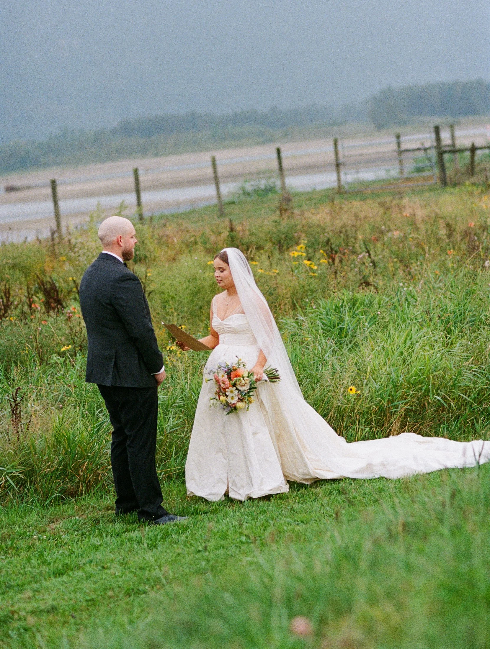 Bride and groom sharing private vows at Fraser River Lodge surrounded by nature and mountain scenery, photographed with hybrid film and digital wedding photography.