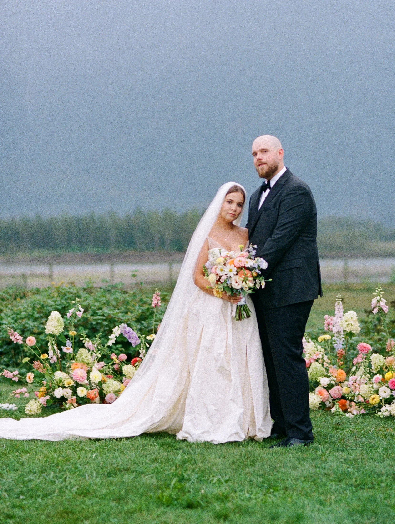 Fraser River Lodge editorial wedding portraits outdoors featuring the ceremony floral design as a backdrop, photographed with modern digital and nostalgic 35mm film.