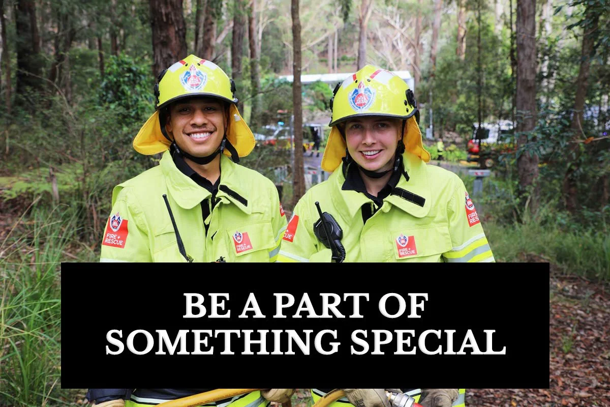 Two Fire and Rescue volunteers stand next to each other in uniform smiling, standing in the bush. TEXT: Be a part of something special.