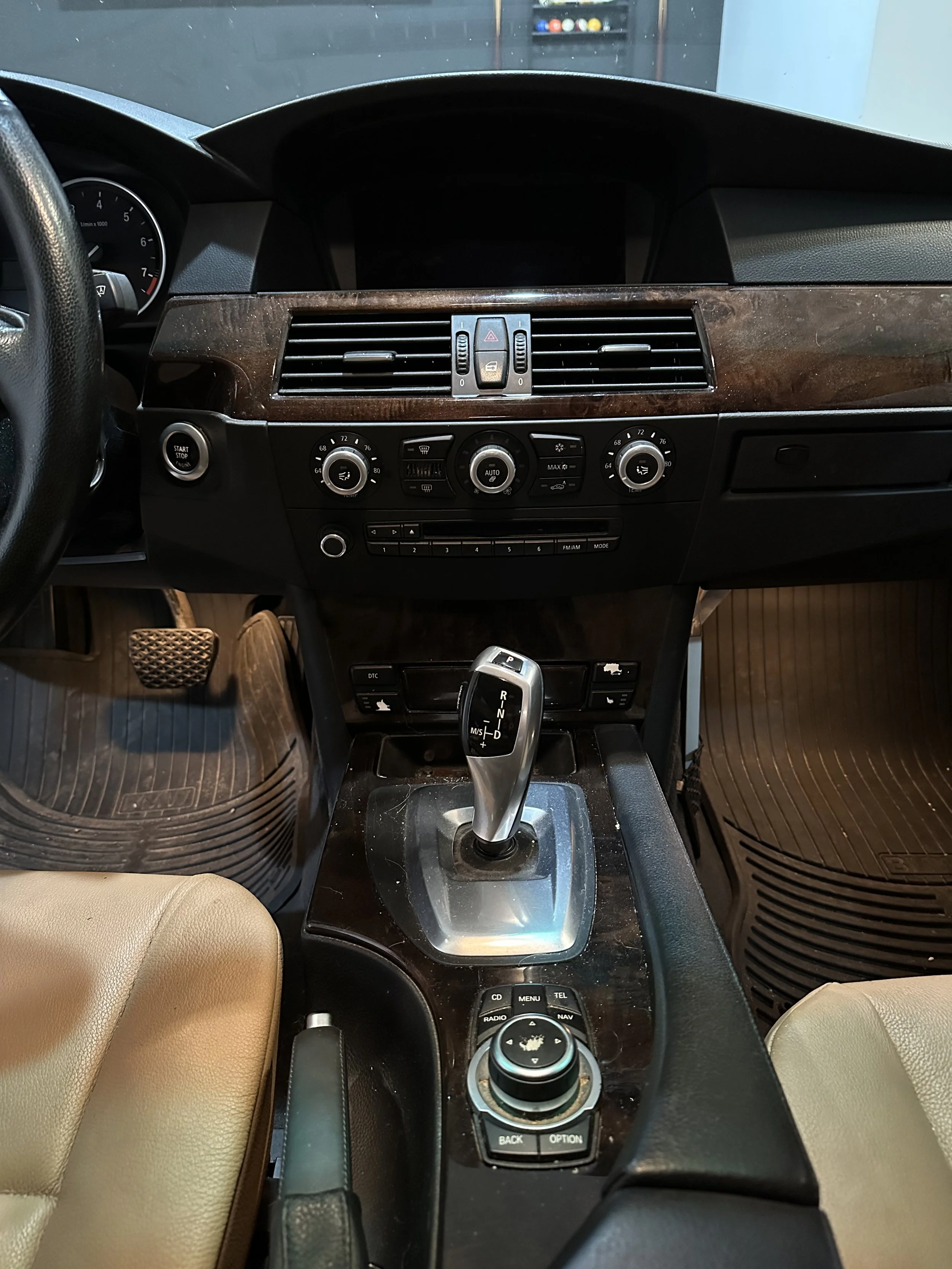 Car interior showing dashboard, gear shifter, and control panels.
