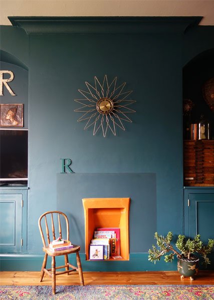 blue-painted-wall-orange-fireplace