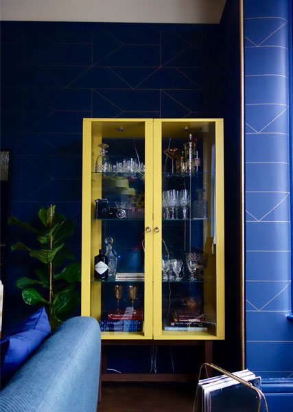 yellow-drinks-cabinet-navy-blue-wall