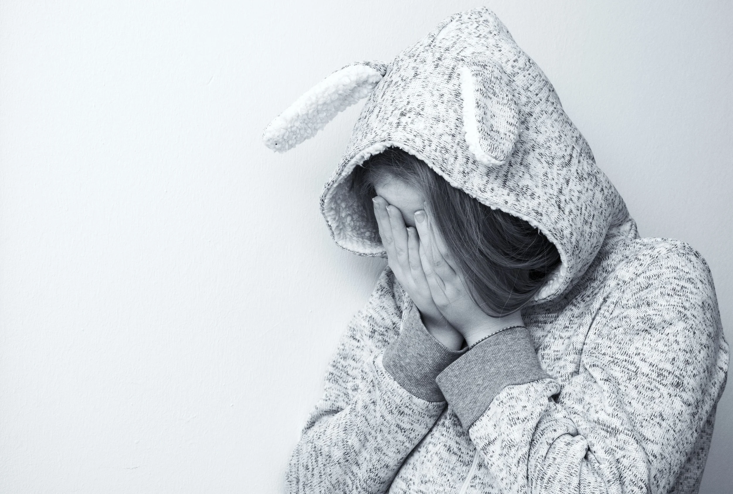 Child covering their face while processing childhood emotional neglect, representing how EMDR therapy supports LGBTQ+ clients in healing trauma and emotional wounds.