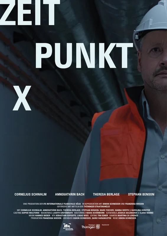 Person wearing a safety helmet and orange safety vest, standing in an industrial setting, with partial text 'ZEIT PUNKT' in the background.
