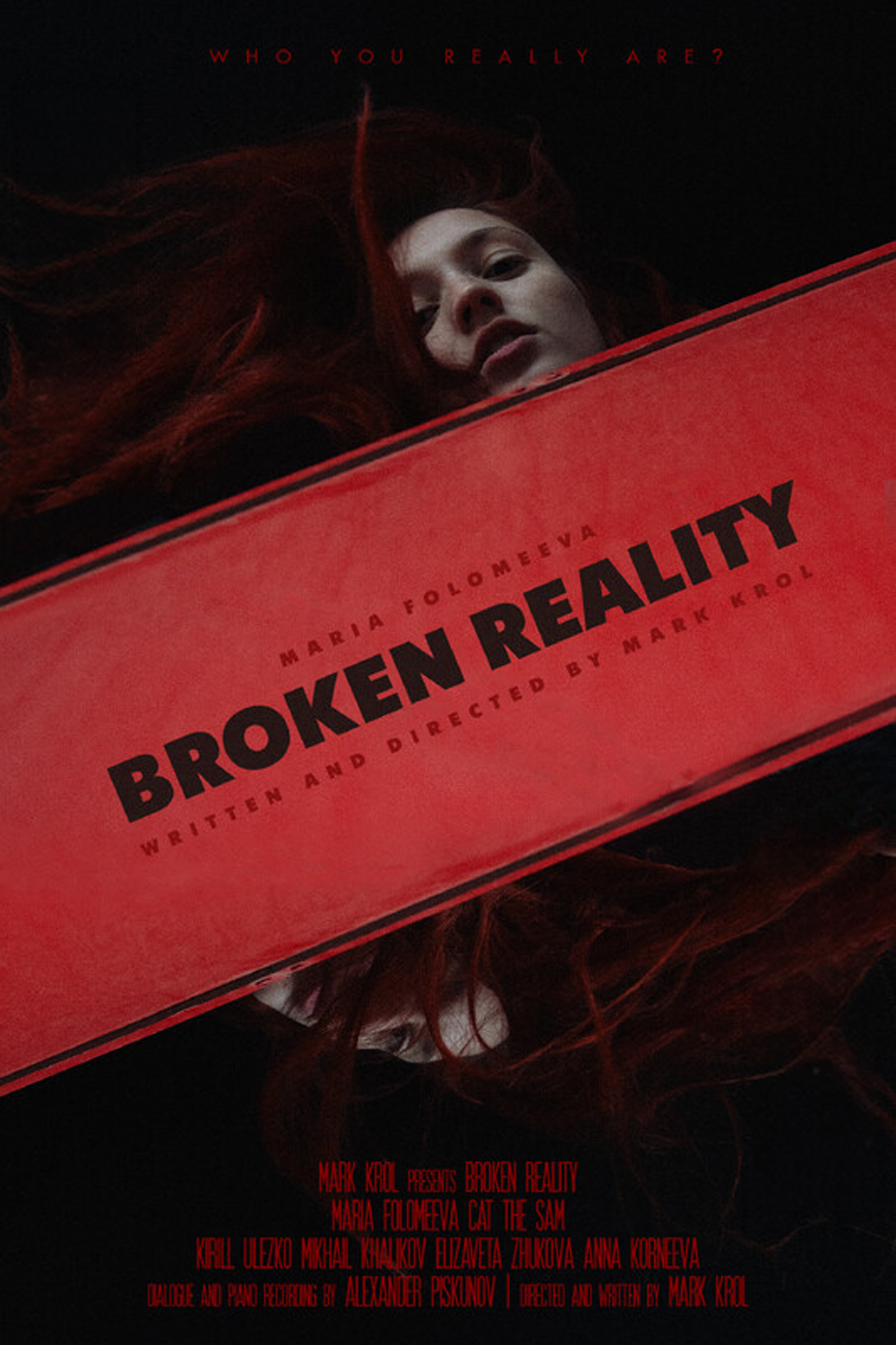 A promotional poster for the movie 'Broken Reality' featuring a woman with long red hair, looking downward. The film is written and directed by Mark Krol and stars Maria Folomeva. The poster has a red and black color scheme with the title prominently in bold black letters.