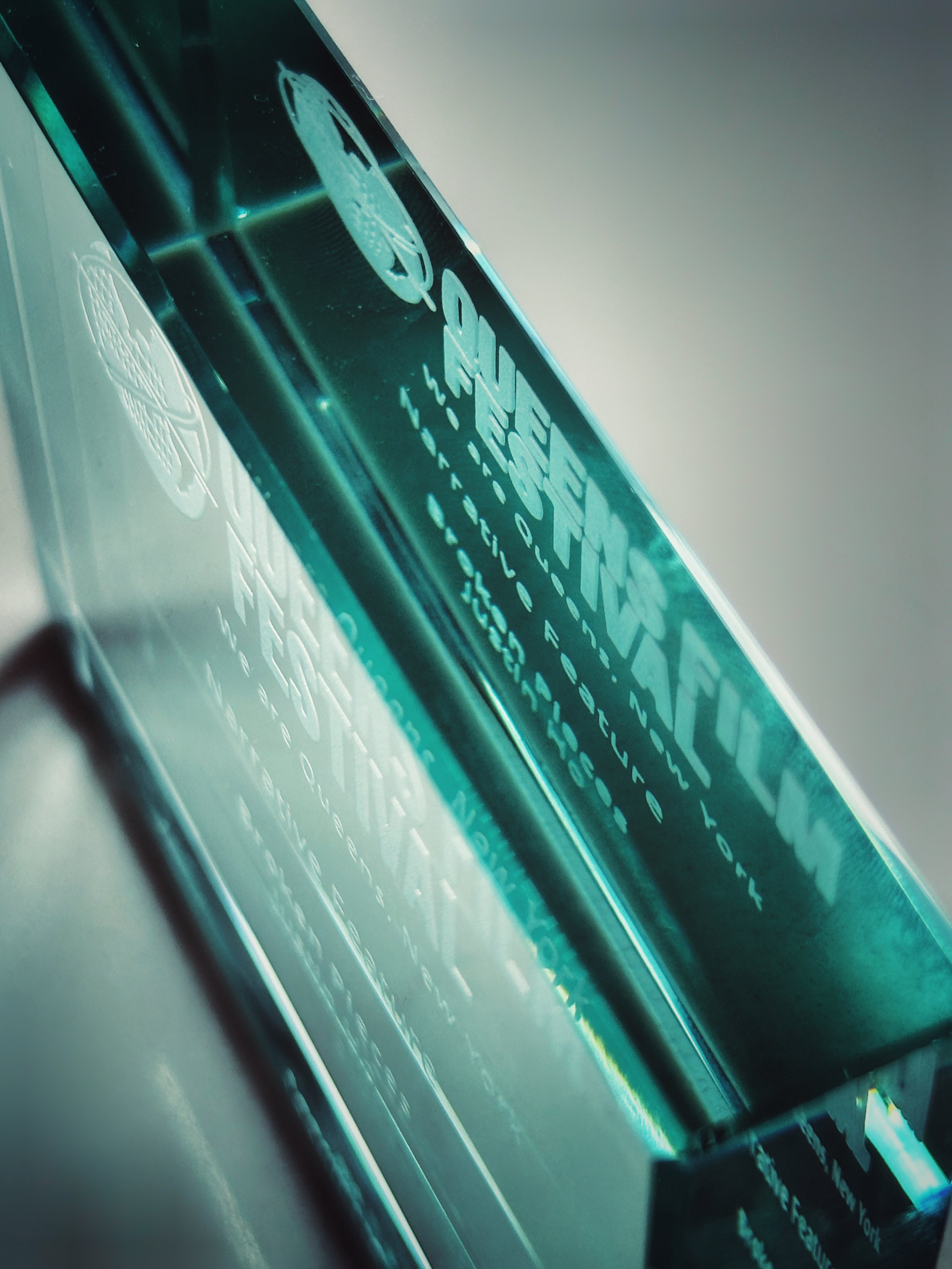 Close-up view of a digital screen displaying text and graphics, with a blue-green tint and reflections.