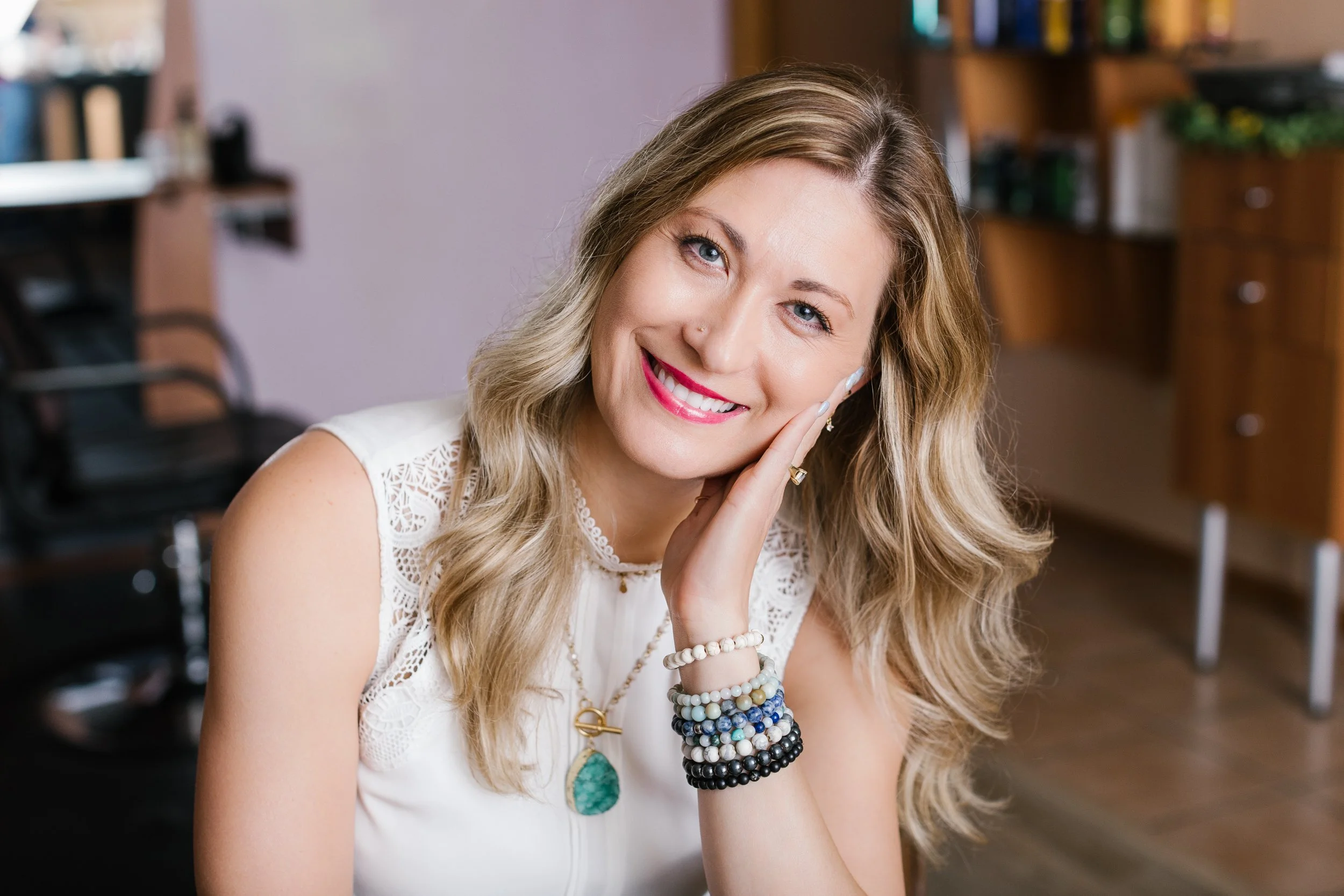 Professional headshot of a stylist in her salon