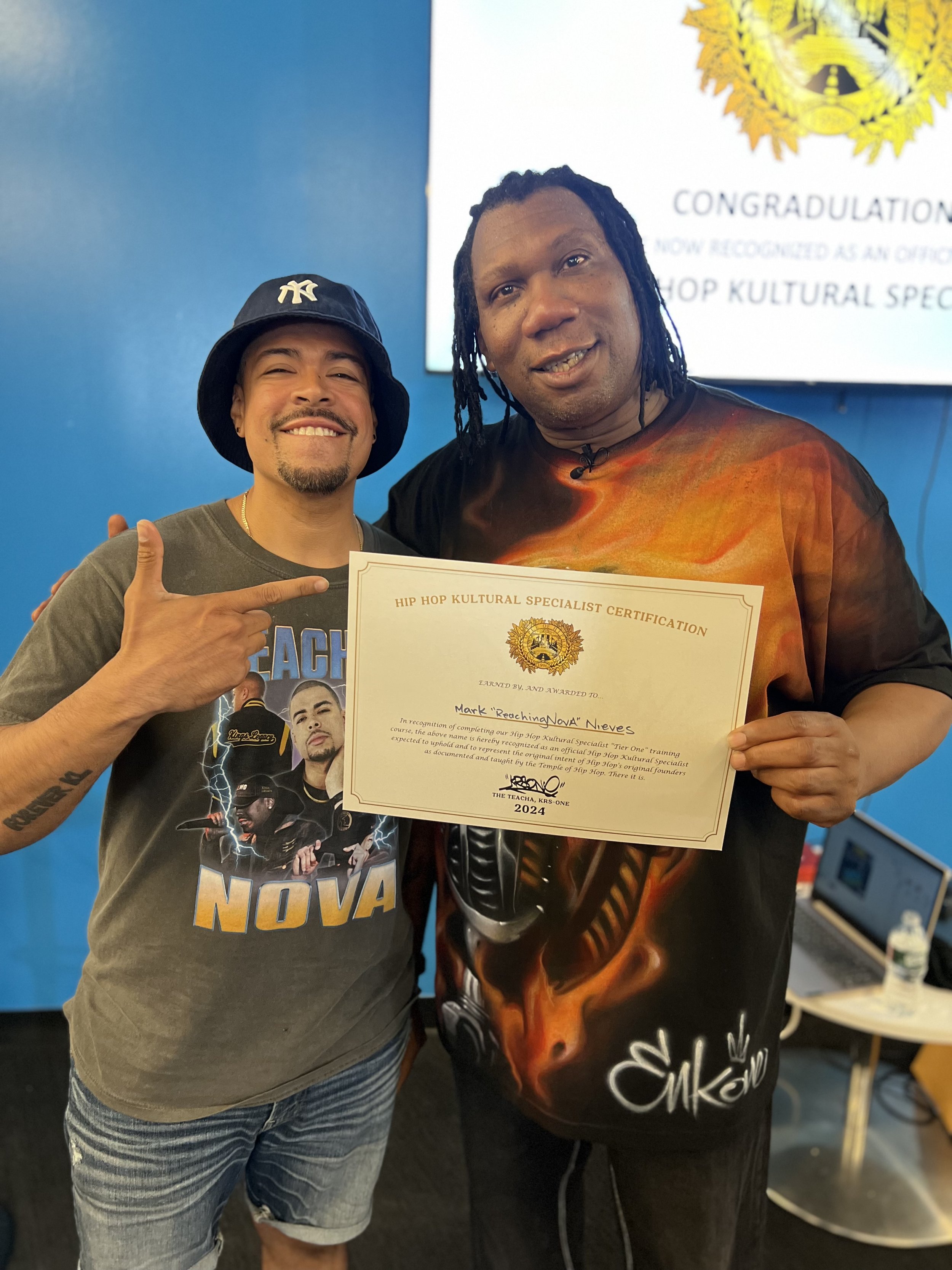 ReachingNOVA with KRS-One holding his Hip Hop Kultural Specialist certification in 2024