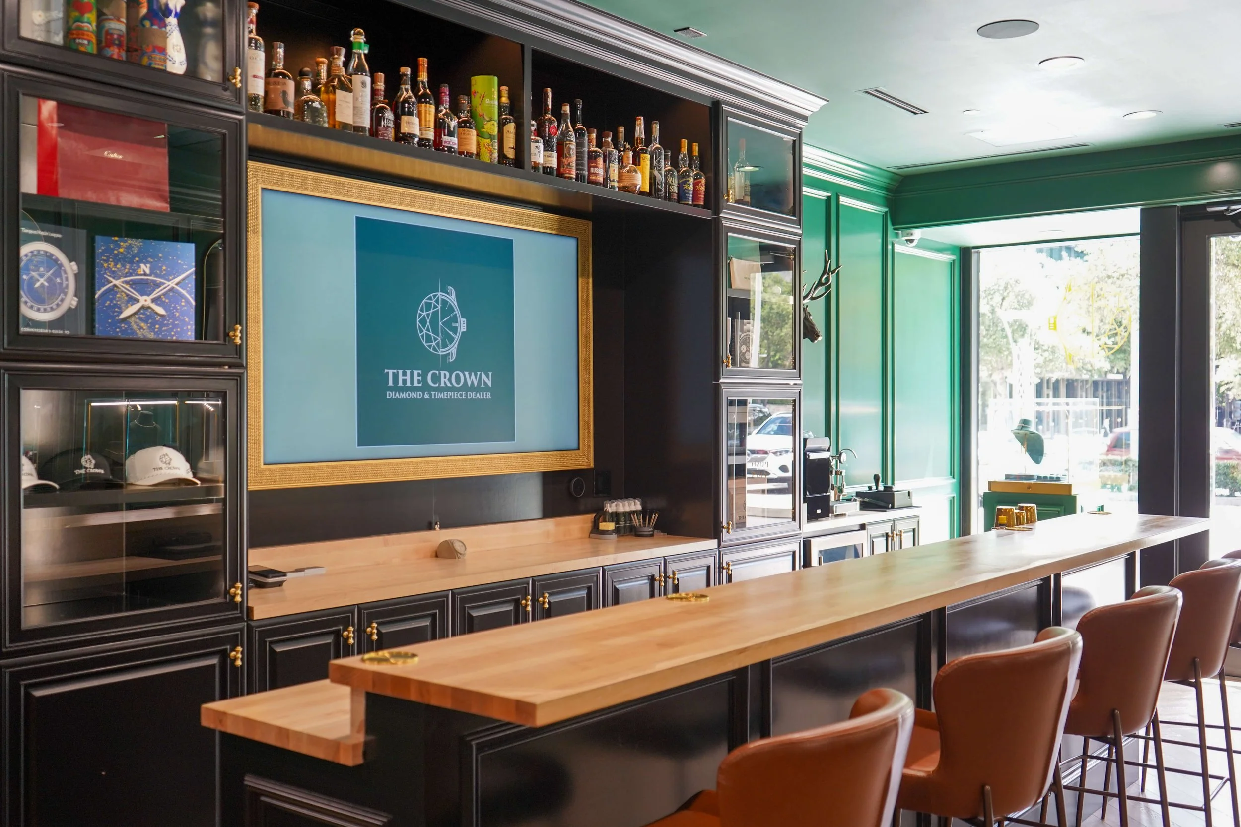 The Crown Houston bar display with curated whiskey and spirits selection