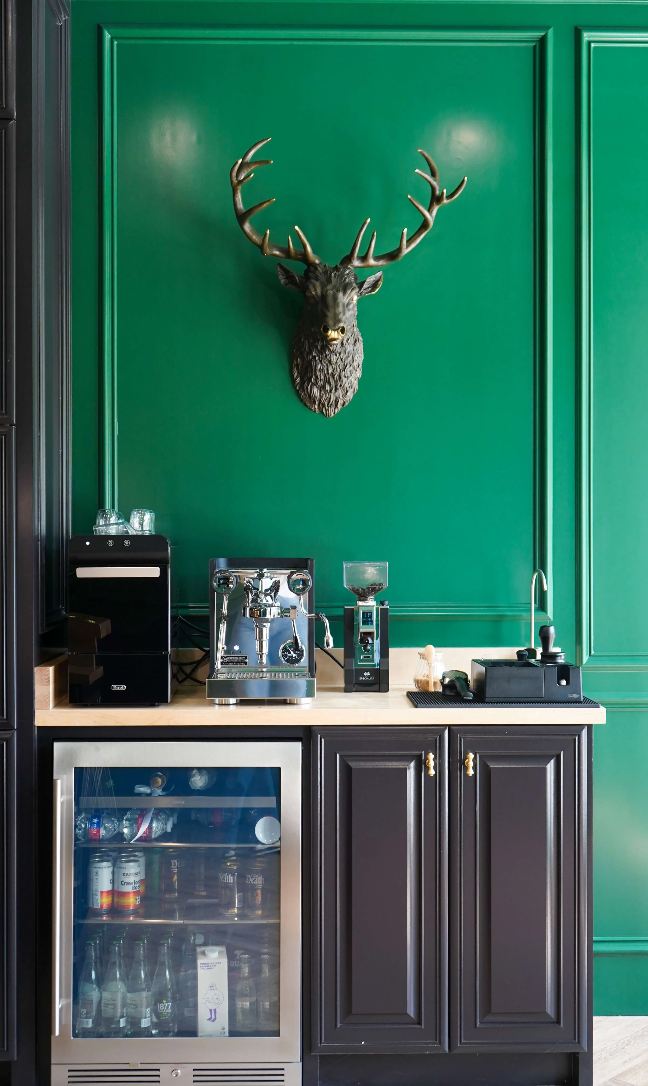 Espresso bar and mounted stag head in The Crown Houston's private lounge