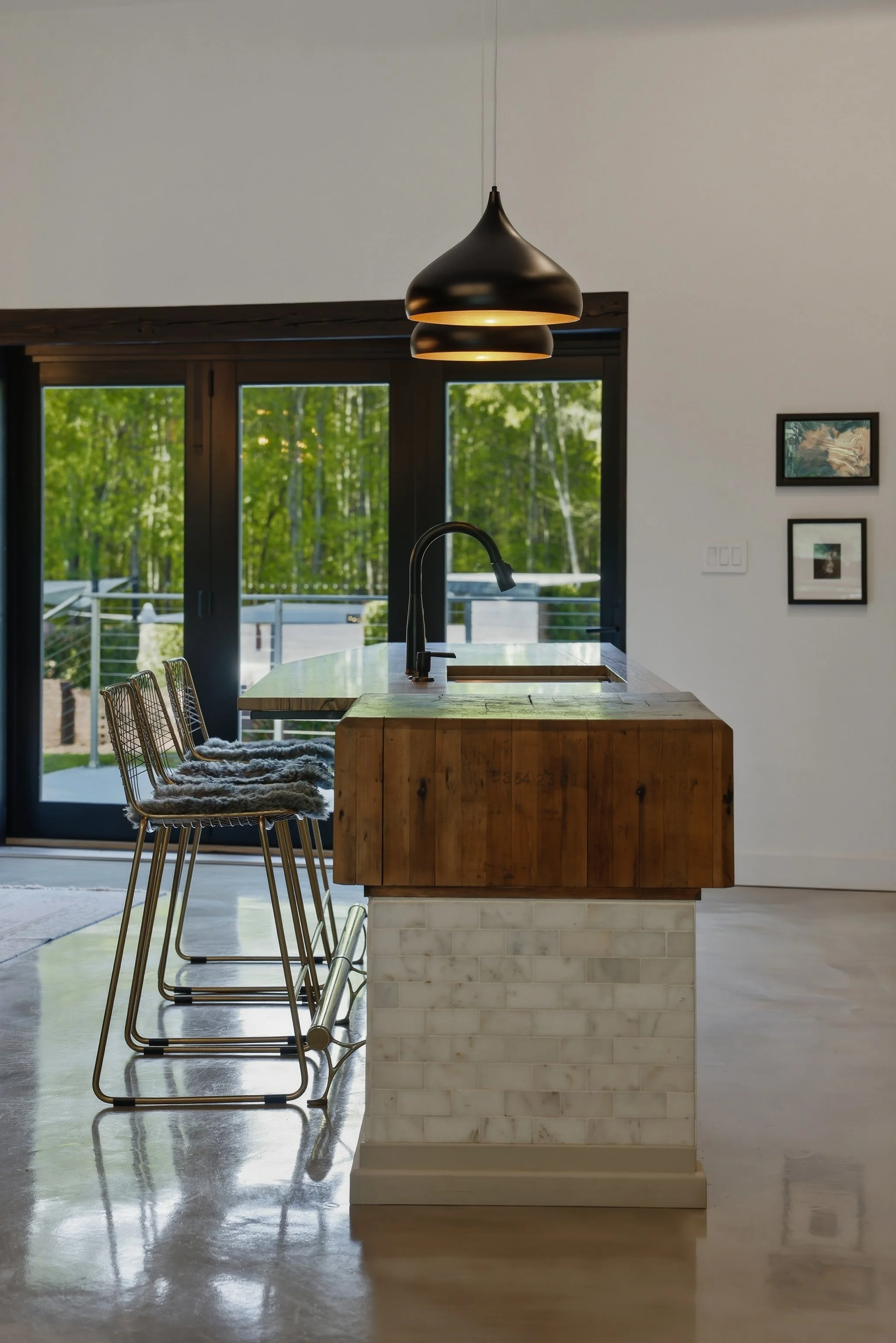 Silver metallic epoxy floors paired with Carrara marble add an elegant glow to the room