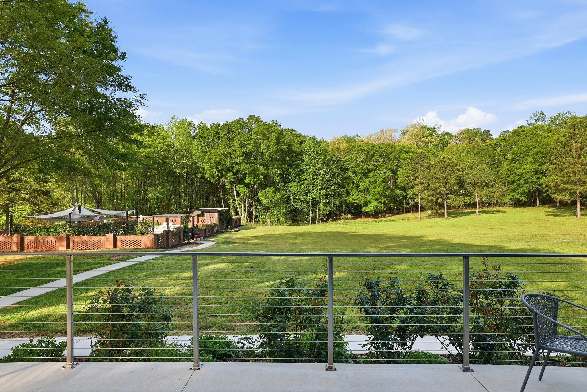 Custom stainless steel cable railing adds to the home's modern elegance and strength