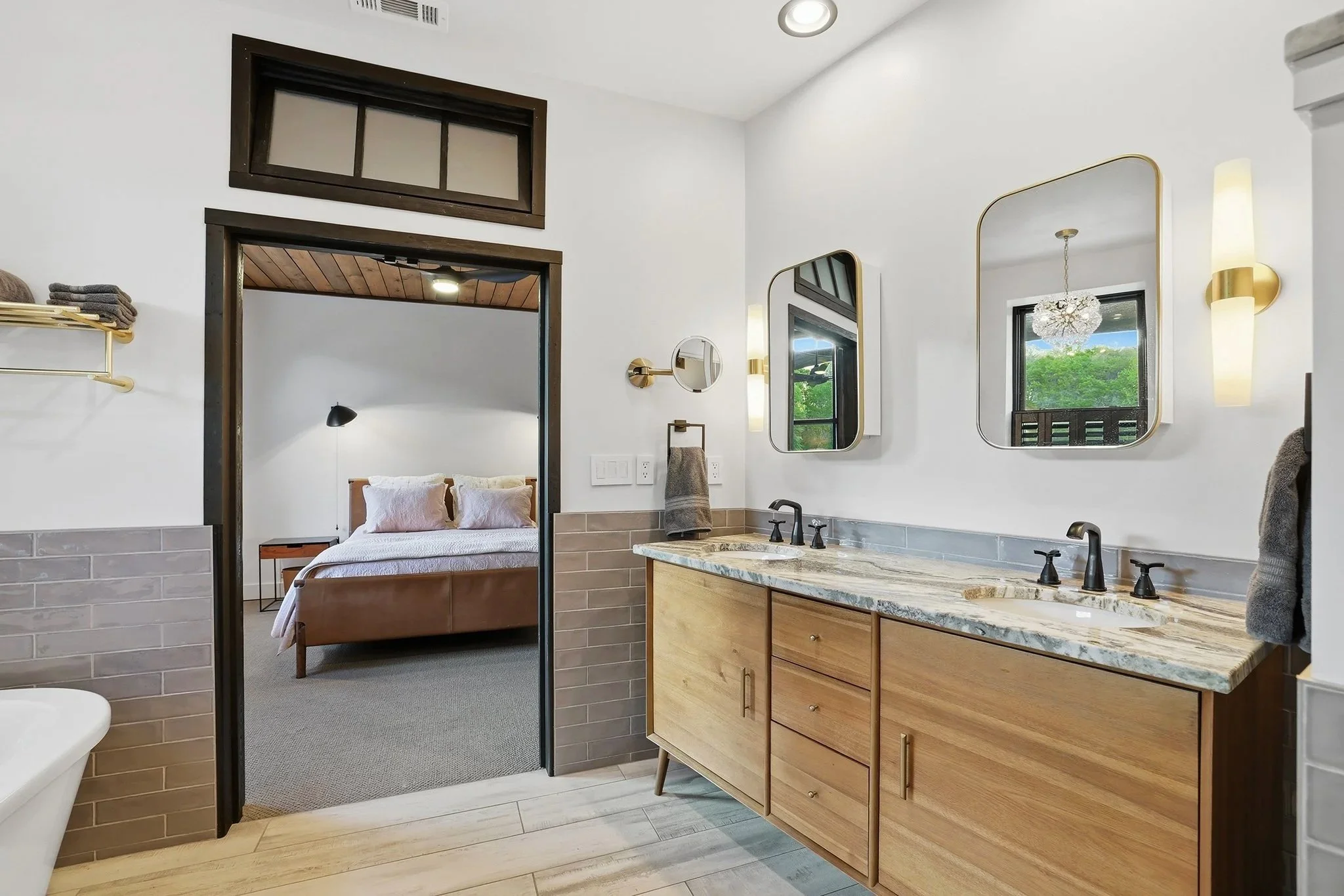 Primary bath designed with a transom window, porcelain tile, and warming radiant floors