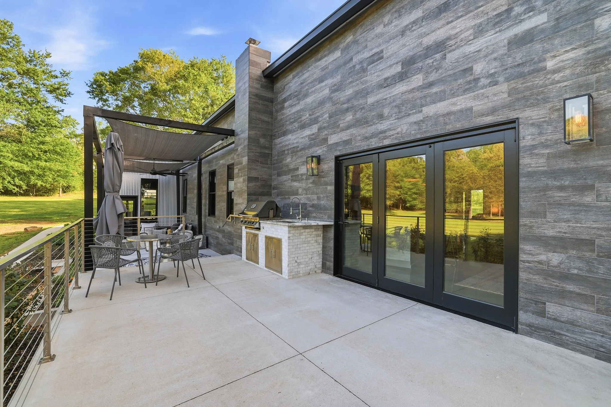 Upper deck with Sierra Pacific tri-fold doors features a fully tiled, low-maintenance exterior wall