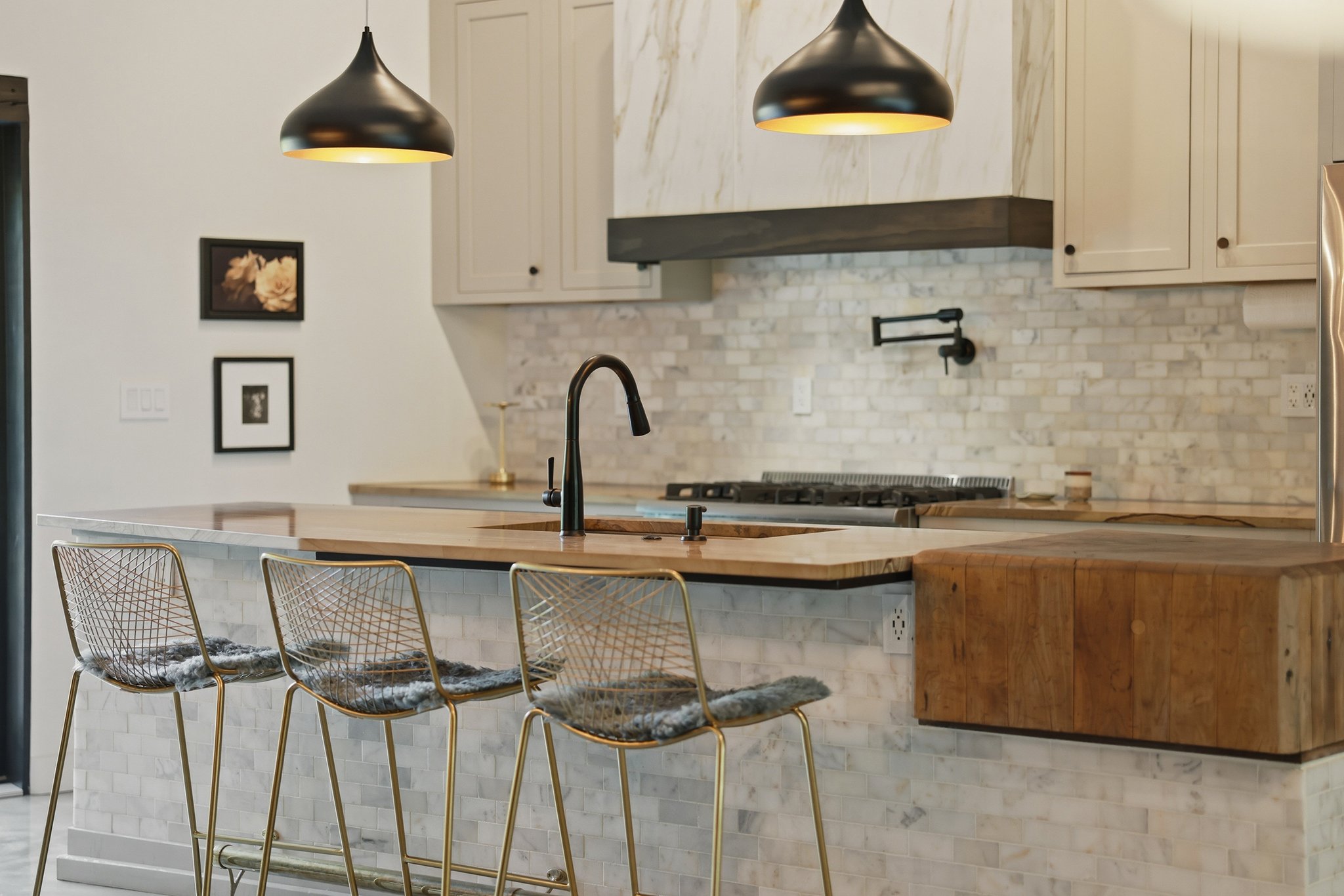Expansive 11' sandstone counter with built-in butcher block, perfect for hosting