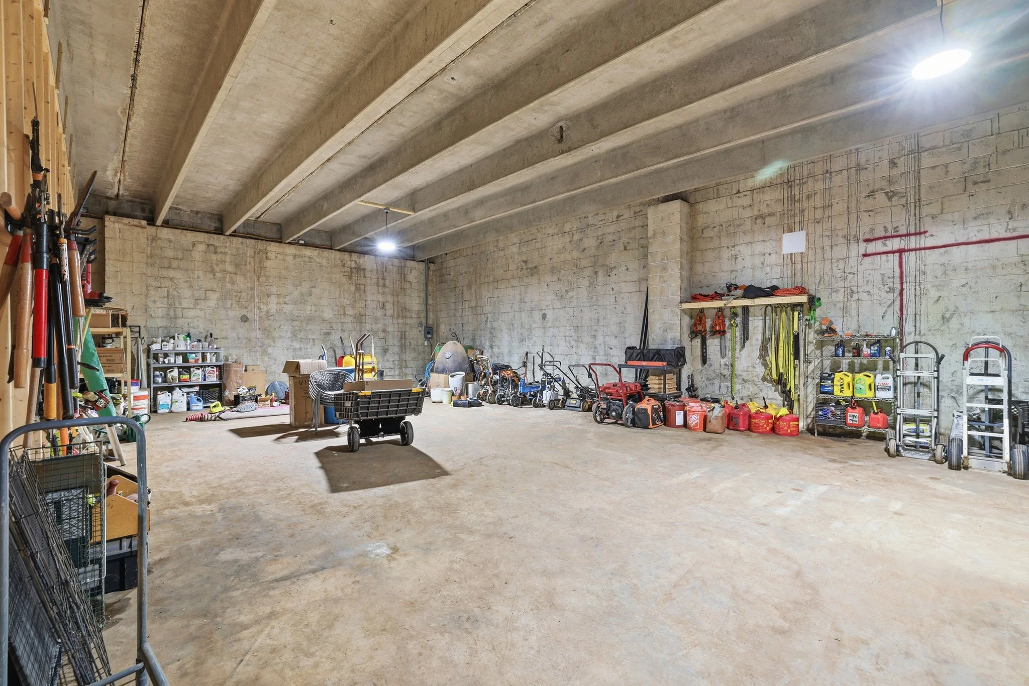 Inside, the generous 5,000 sq ft interior impresses with soaring 14-foot concrete bridge truss ceilings