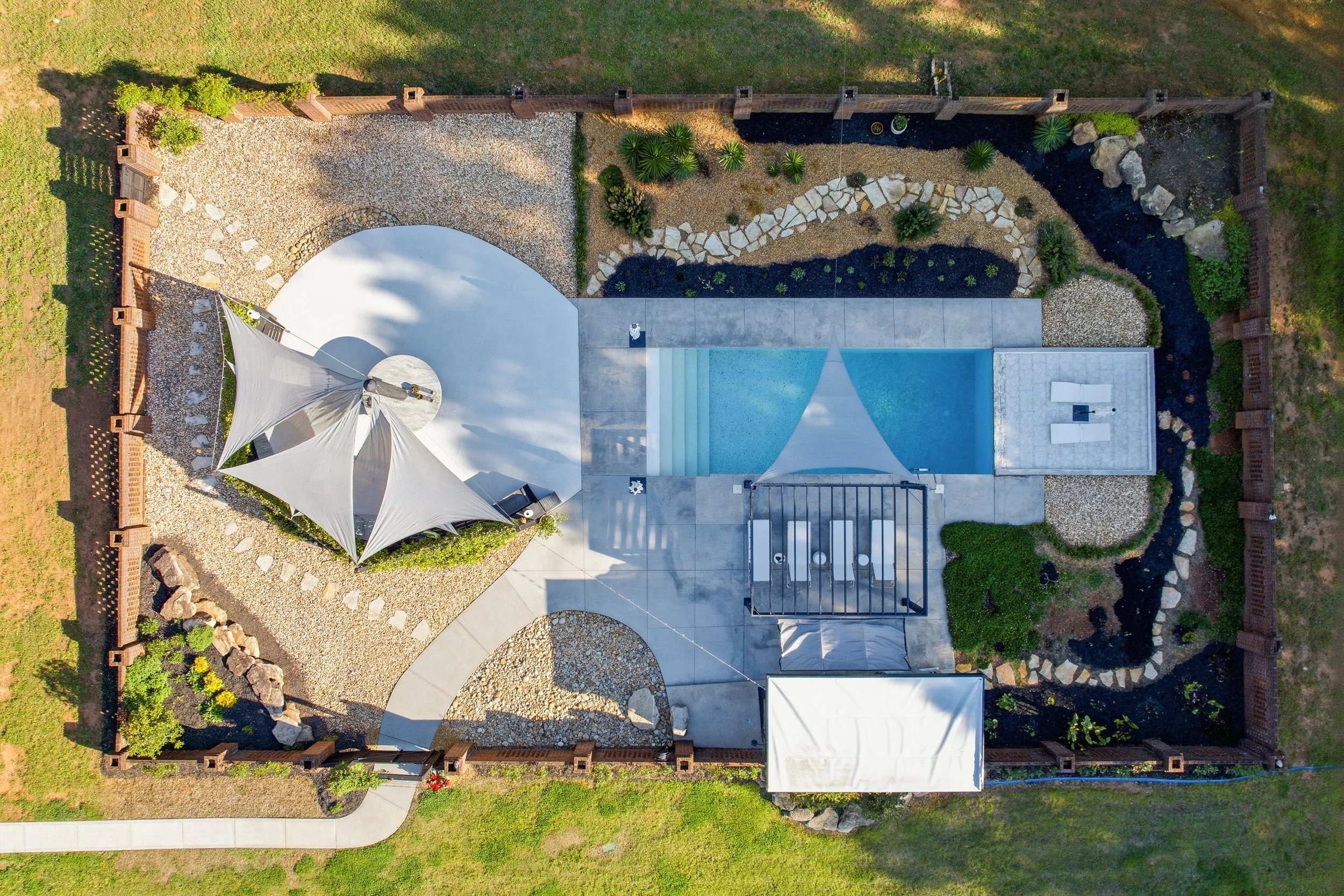 Overhead shot of the pool, lounge, and gardens
