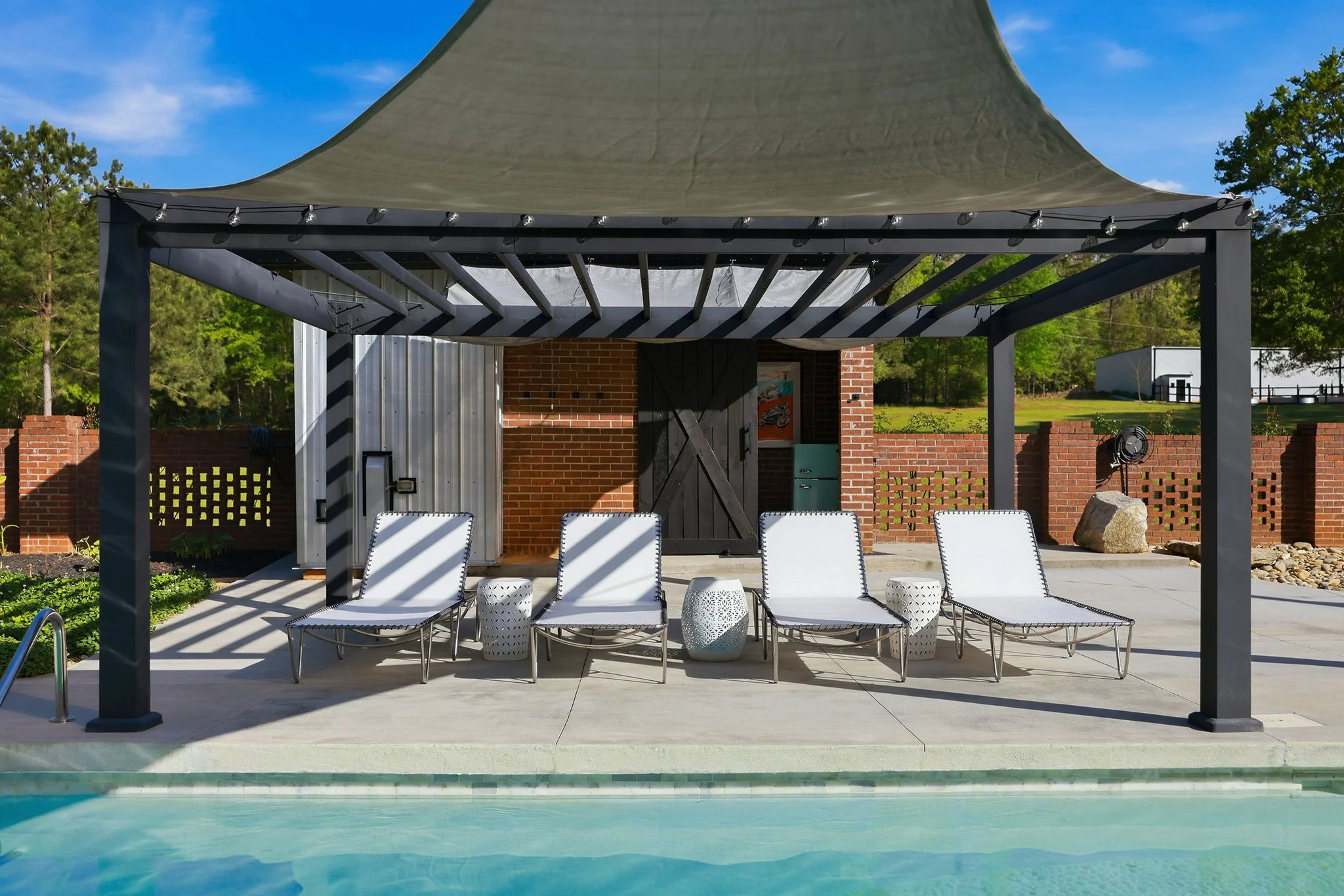 The poolside pergola fits four chaises perfectly and immediately puts you in vacation mode