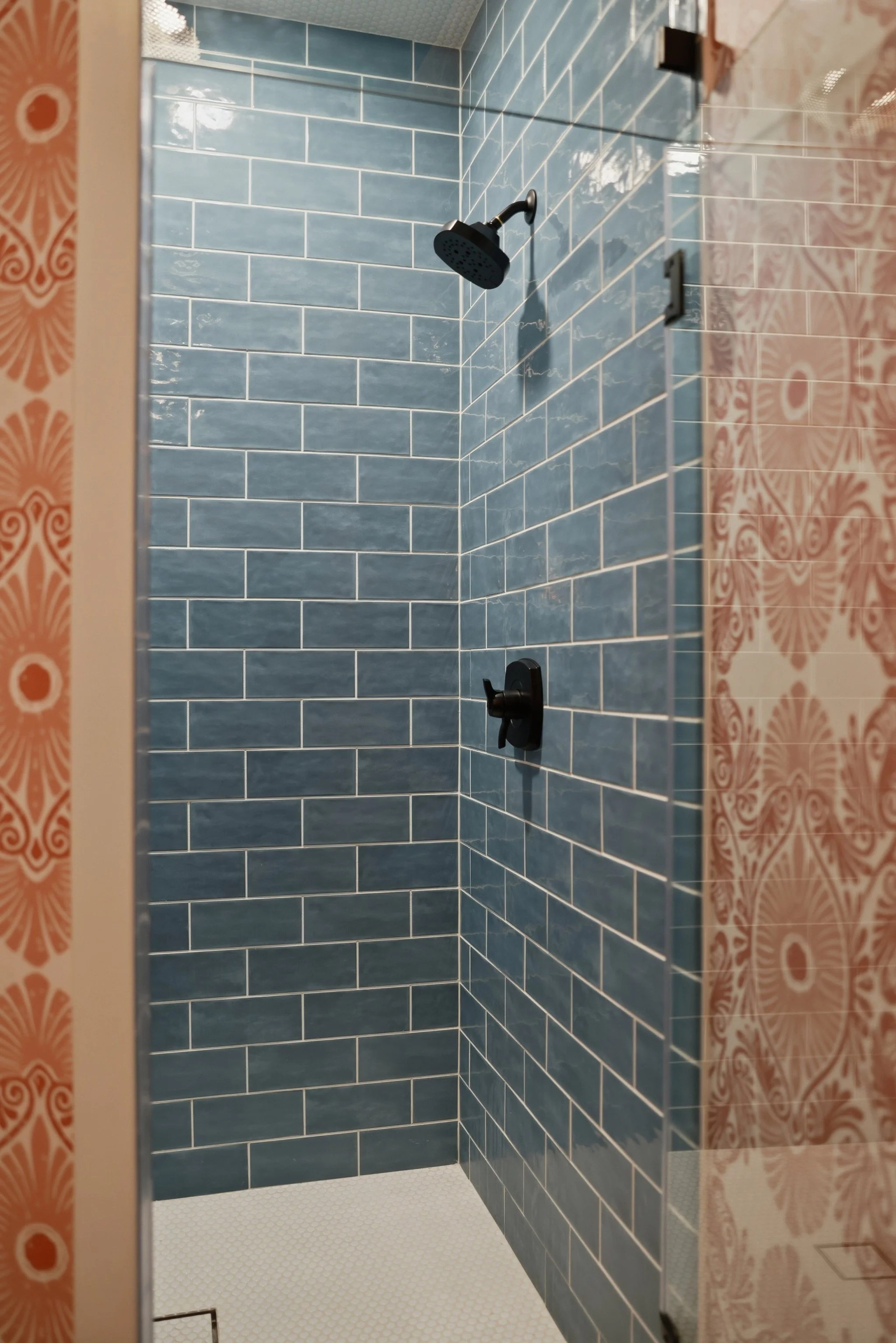 Experience the spa-like feel of the guest shower with floor-to-ceiling tile and glass enclosure