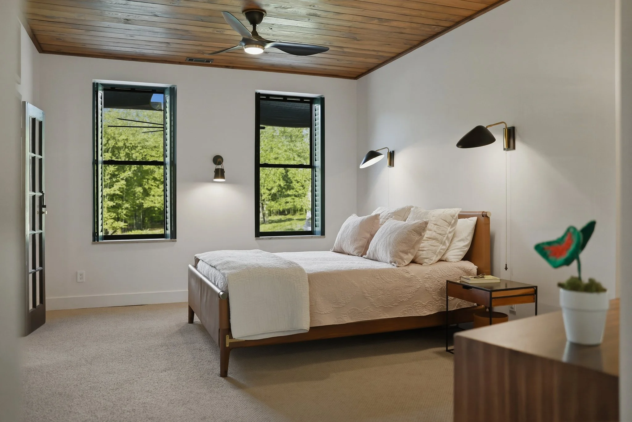 Expansive double-hung windows fill the space with natural light and offer tranquil views of the backyard