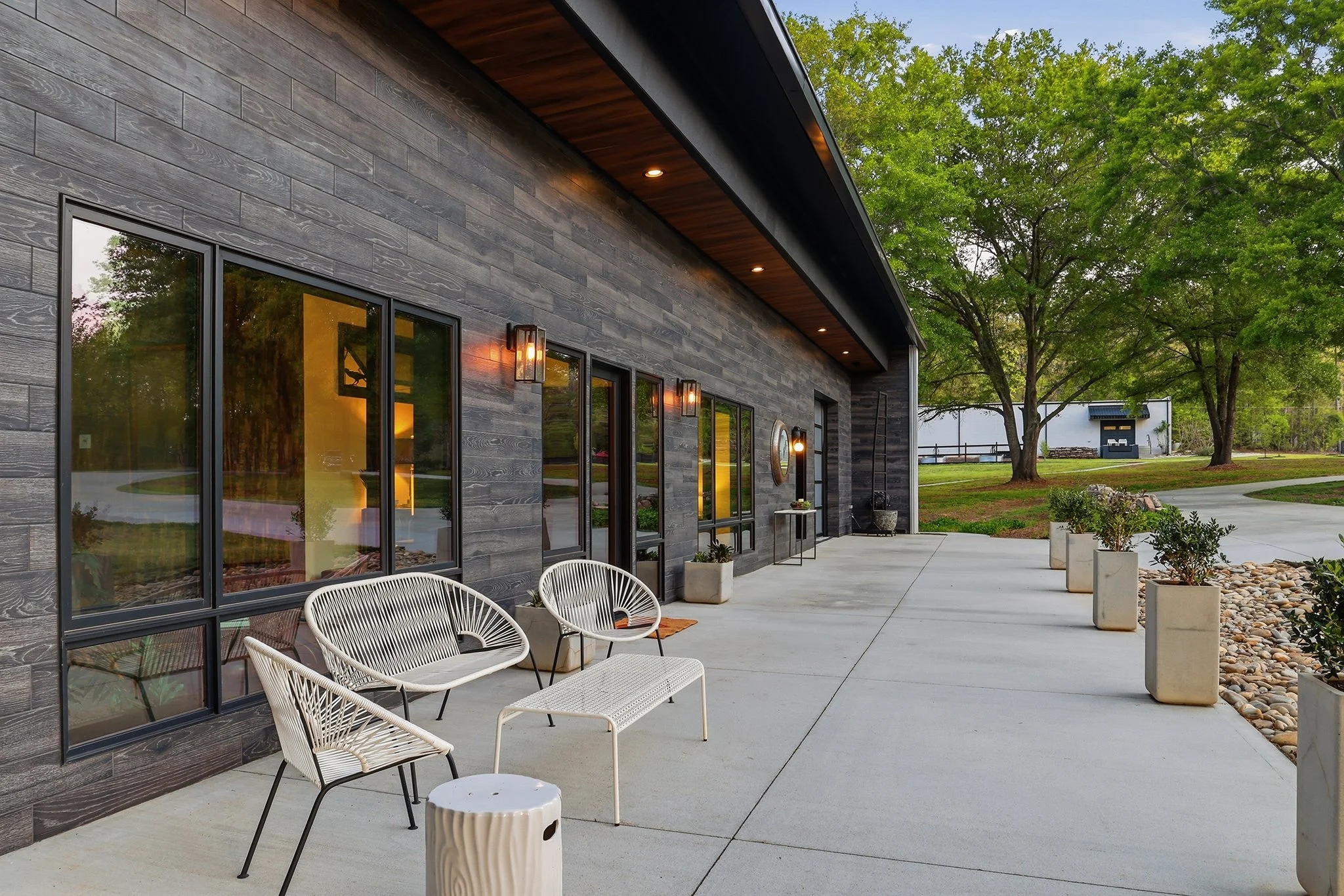 Twilight view of the inviting front patio seating area